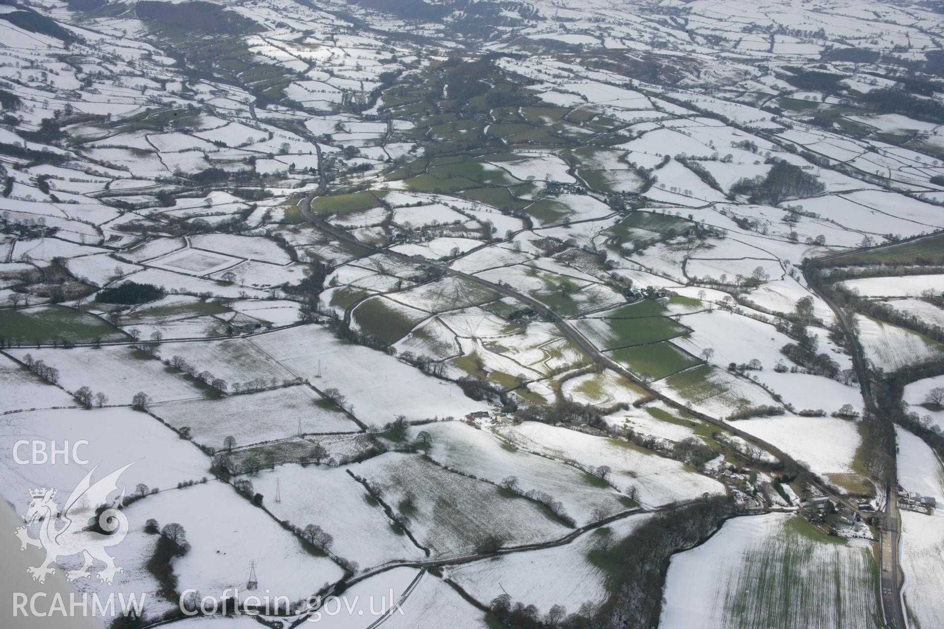 RCAHMW colour oblique aerial photograph of Druid Square Barrows in winter landscape viewed from the east. Taken on 06 March 2006 by Toby Driver