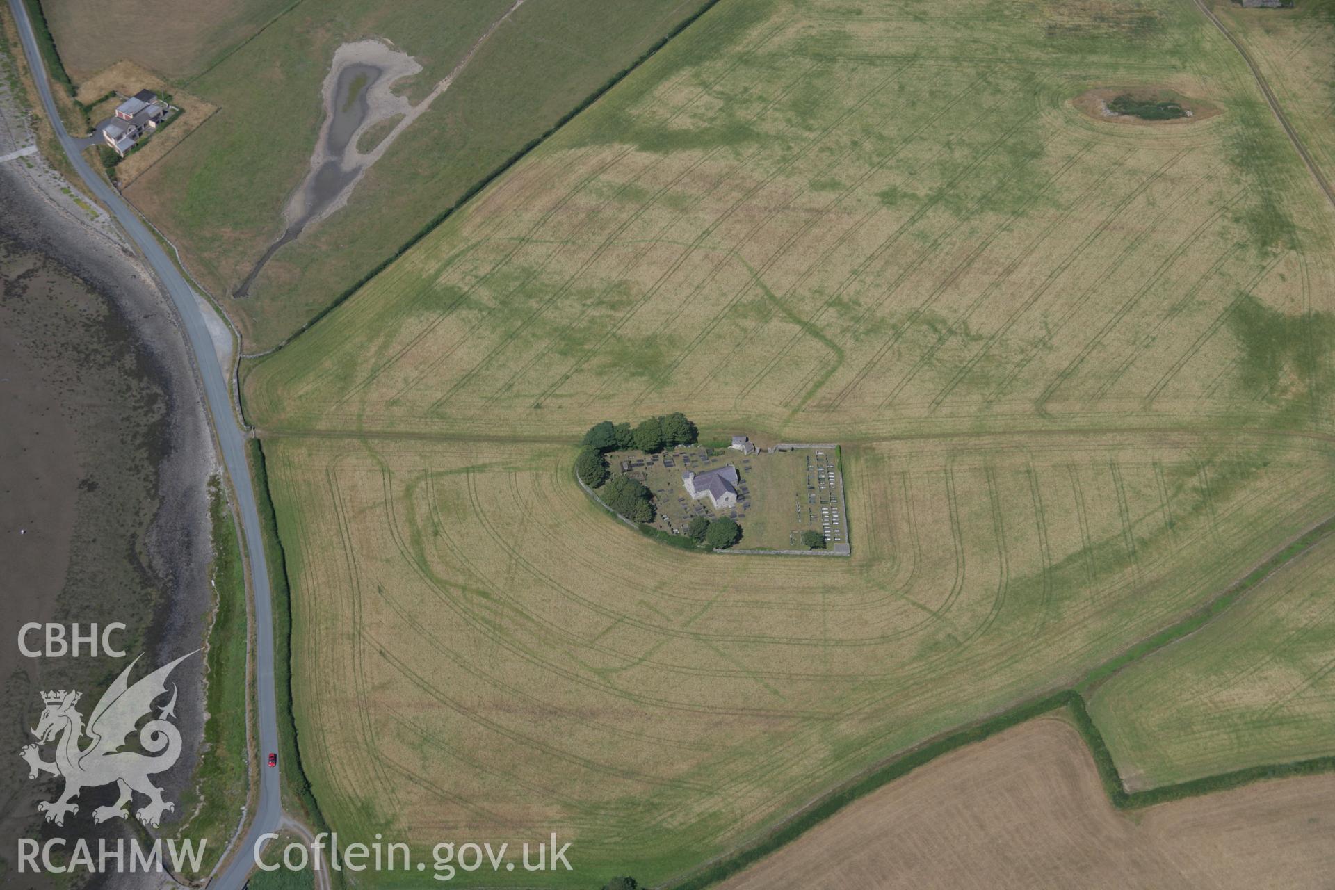 RCAHMW colour oblique aerial photograph of St. Baglan's Church Enclosure Complex. Taken on 25 July 2006 by Toby Driver.