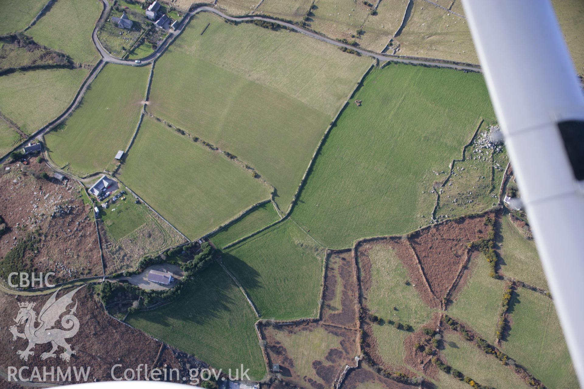 RCAHMW colour oblique aerial photograph of Rhiw Burial Chambers from the south-east. Taken on 09 February 2006 by Toby Driver.