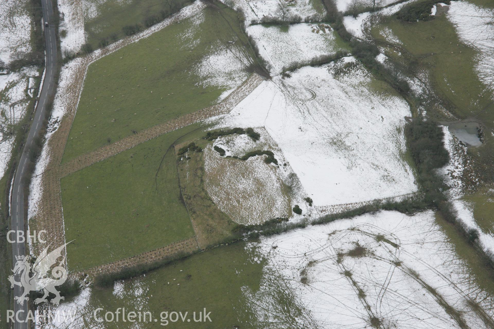 RCAHMW colour oblique aerial photograph of Moel Fodig Defeneded Enclosure, viewed from the north-east. Taken on 06 March 2006 by Toby Driver.