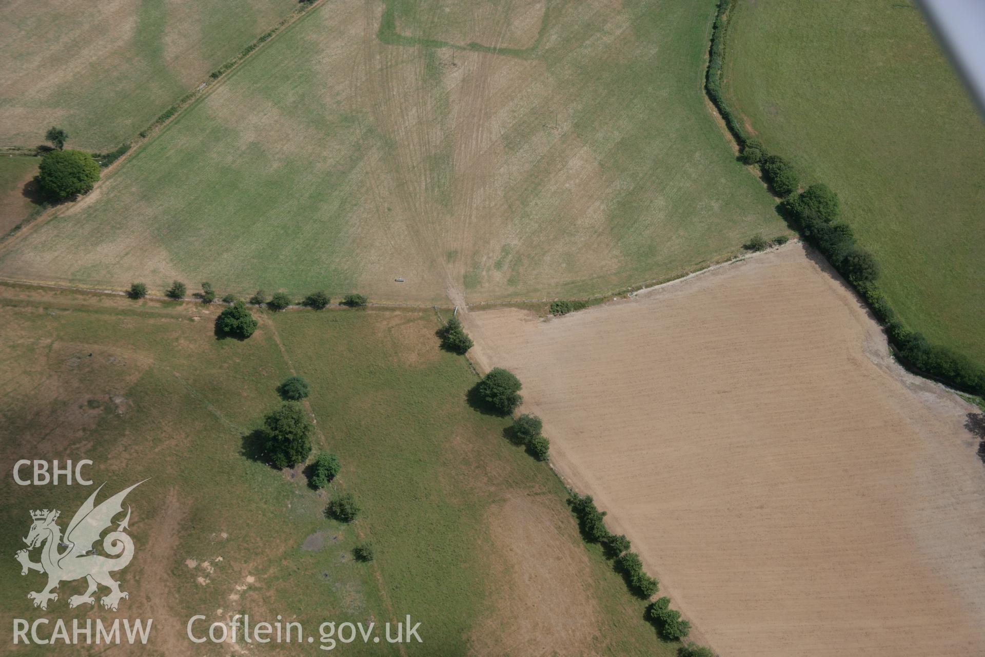 RCAHMW colour oblique aerial photograph of a bivallate enclosure west of Caerau, possibly representing a villa enclosure. Taken on 27 July 2006 by Toby Driver.