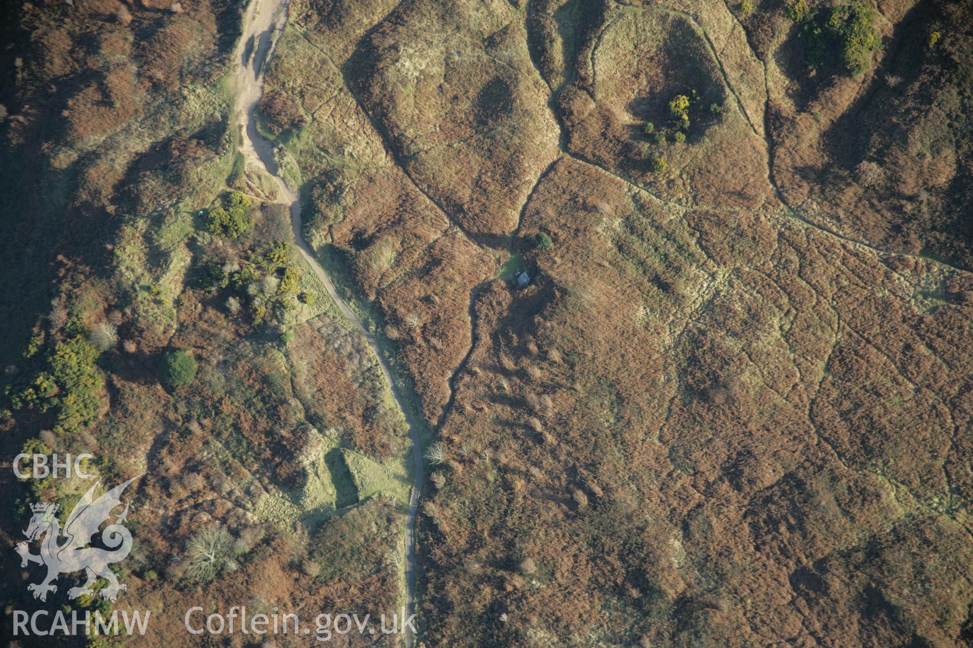 RCAHMW colour oblique aerial photograph of Penmaen Burrows Burial Chamber, viewed from the north-west. Taken on 26 January 2006 by Toby Driver.