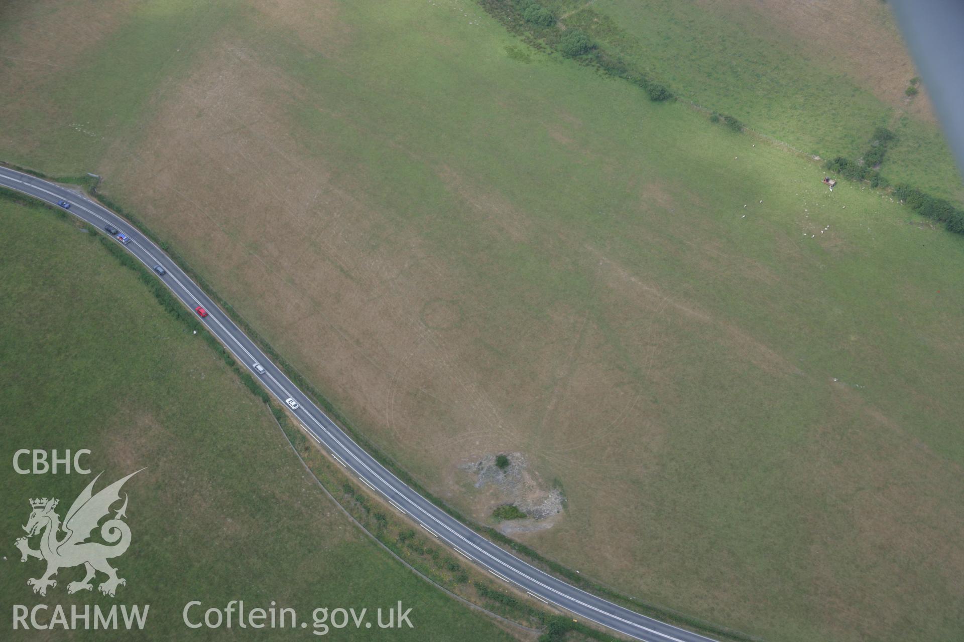 RCAHMW colour oblique aerial photograph of a cropmark ring-ditch southwest of Berth-Rhys. Taken on 21 July 2006 by Toby Driver.