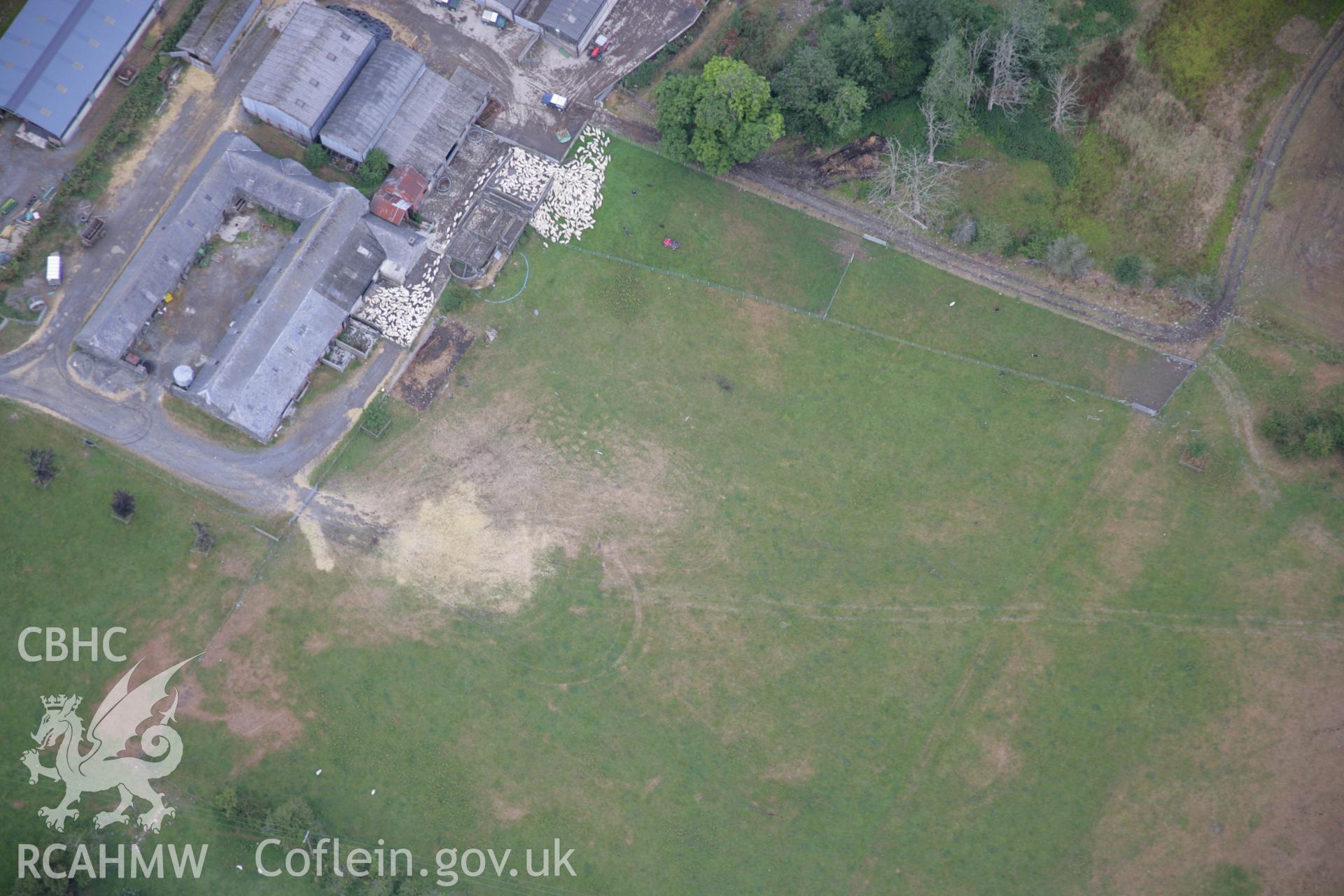 RCAHMW colour oblique aerial photograph of Rhiwlas Garden, Bala, fromm the south-west showing farm buildings, parchmarks of a silage bale stack and other marks. Taken on 31 July 2006 by Toby Driver.