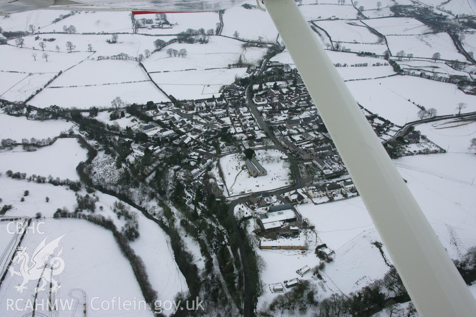 RCAHMW colour oblique aerial photograph of Llanarmon-yn-Ial, viewed from the east. Taken on 06 March 2006 by Toby Driver.