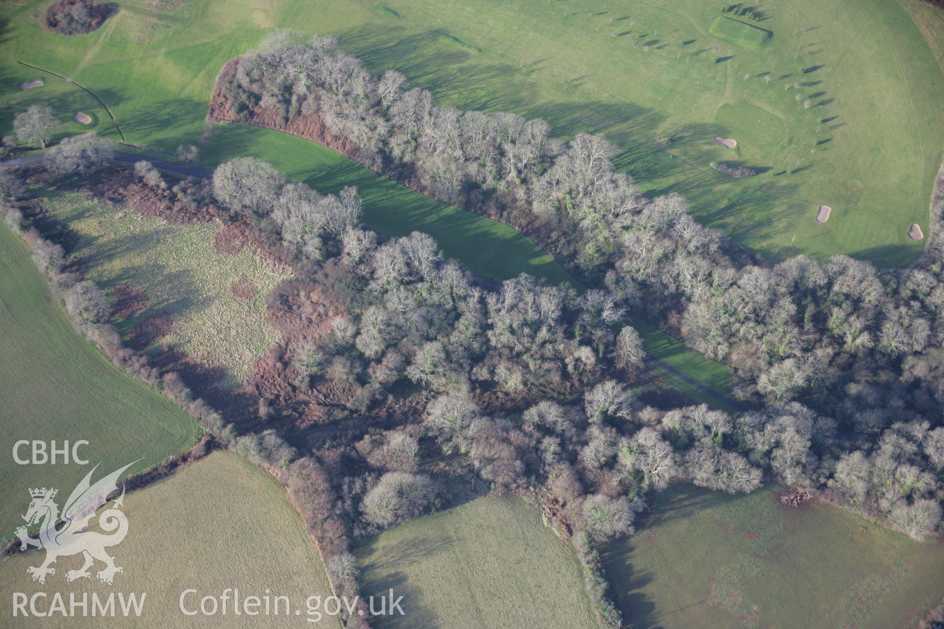 RCAHMW colour oblique aerial photograph of Longberry Bank Cave (Little Hoyle Cave), in general view from the east. Taken on 11 January 2006 by Toby Driver