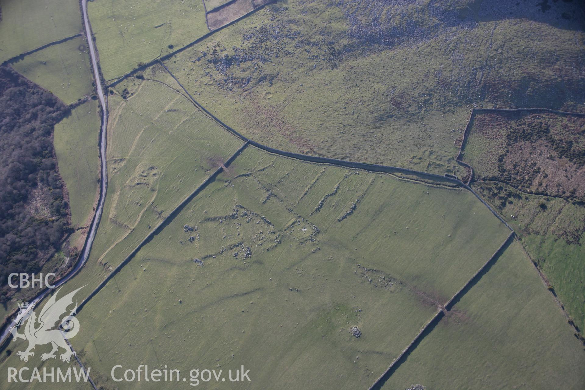 RCAHMW colour oblique aerial photograph of Garn Bach, Pen y Caerau, hut groups and field systems, viewed from the north-east. Taken on 09 February 2006 by Toby Driver