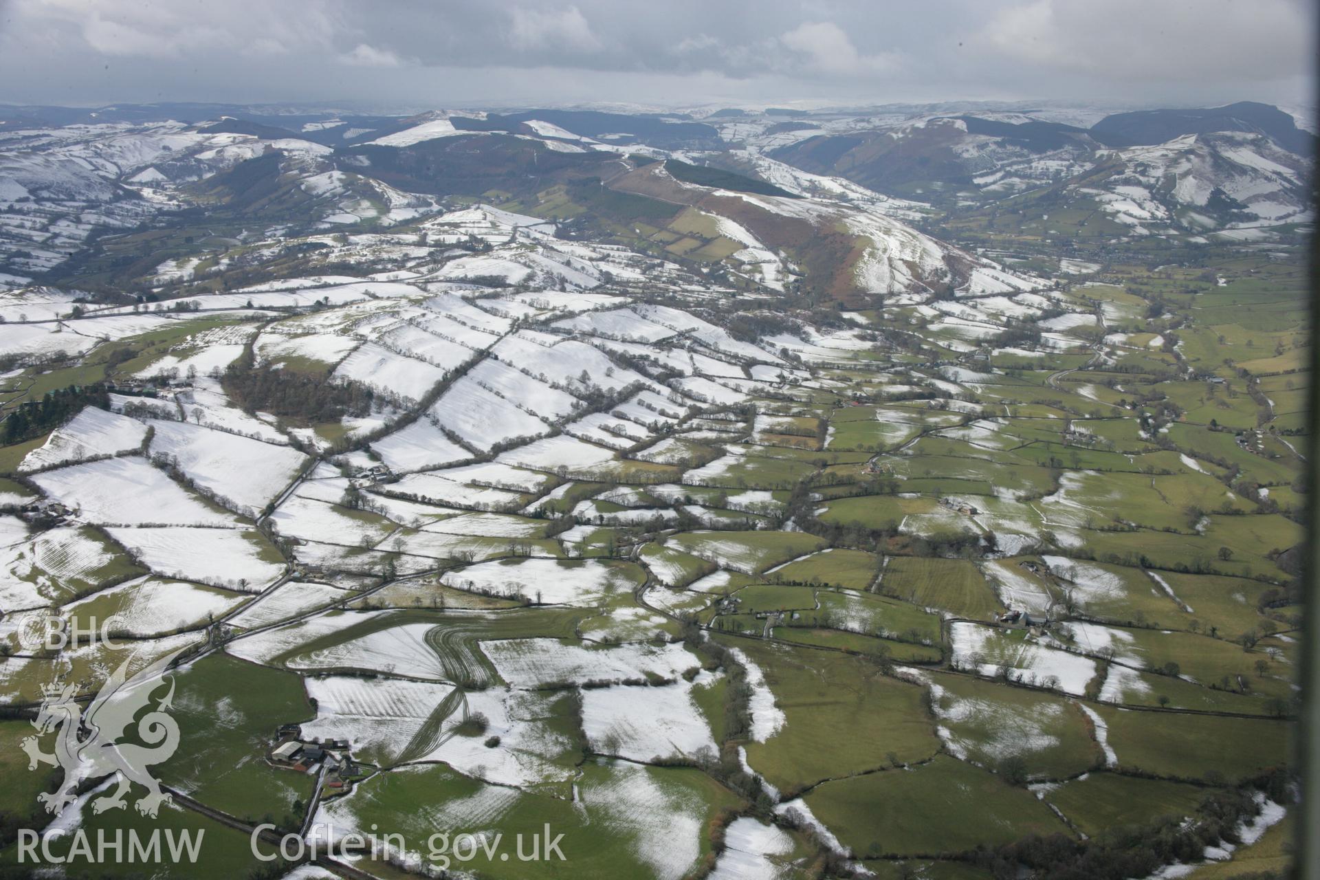 RCAHMW colour oblique aerial photograph of Ty-Newydd Dyke and landscape to the west. Taken on 06 March 2006 by Toby Driver.