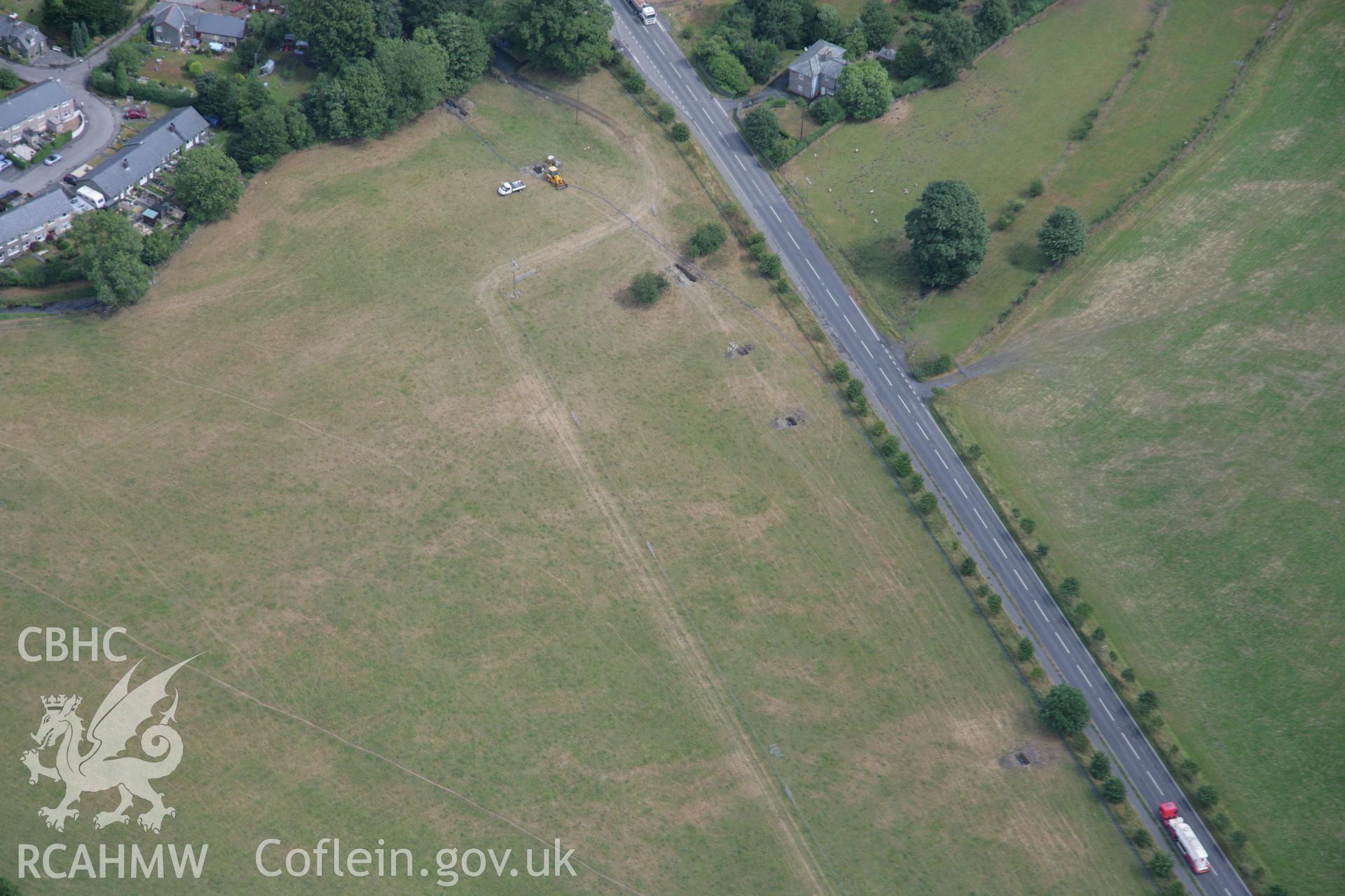 RCAHMW colour oblique aerial photograph of Llanfor Roman Temporary Camp II, visible in cropmarks, viewed from the north-west. Taken on 31 July 2006 by Toby Driver.