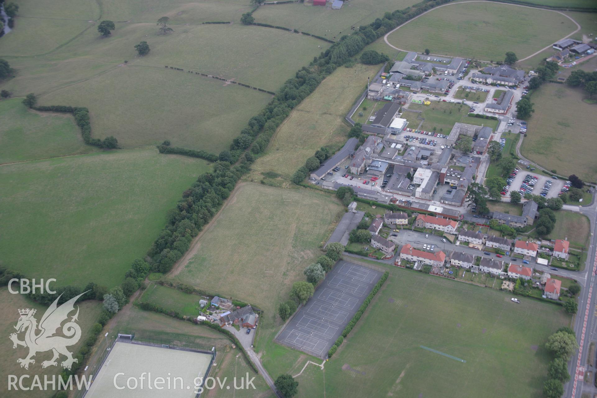 RCAHMW colour oblique aerial photograph of H.M. Stanley Hospital and Chapel showing possible parchmarks of a linear feature, perhaps a road. Taken on 14 August 2006 by Toby Driver.