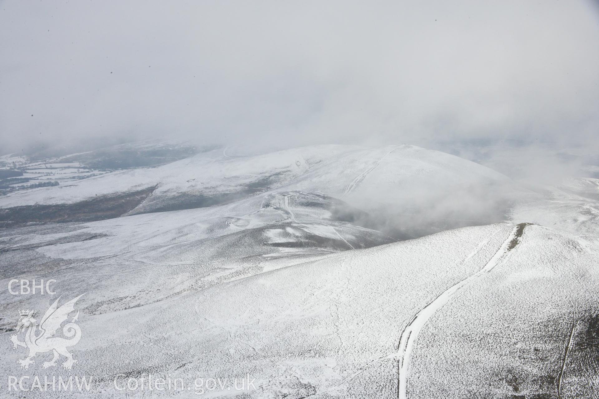 RCAHMW colour oblique aerial photograph of Moel-y-Gaer Hillfort, Llantysilio in winter landscape from the south-west. Taken on 06 March 2006 by Toby Driver.