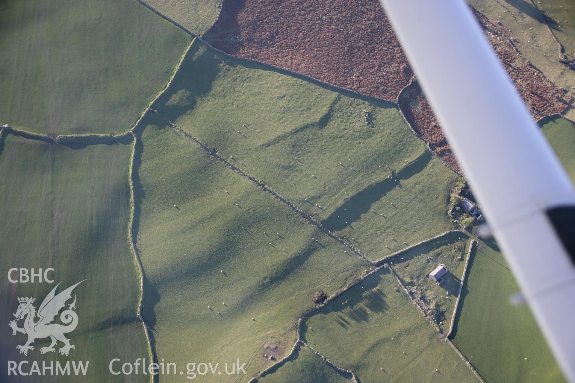 RCAHMW colour oblique aerial photograph of Cae'r-Weirglodd Lynchets from the north-east. Taken on 09 February 2006 by Toby Driver.