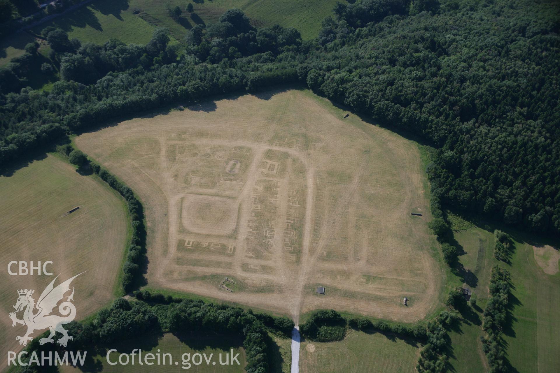 RCAHMW colour oblique aerial photograph of a section of Wat's Dyke from Coed Llys to the Chester to Holywell road. The site of a fair is also visible. Taken on 17 July 2006 by Toby Driver.