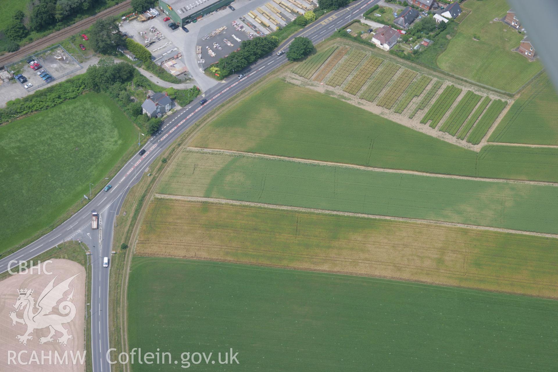 RCAHMW colour oblique aerial photograph of Bow Street Enclosure. Taken on 04 July 2006 by Toby Driver