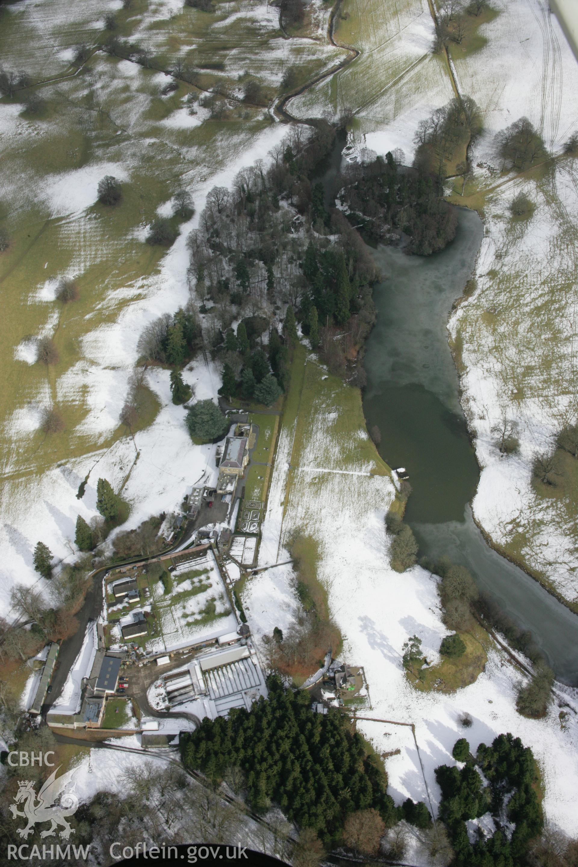 RCAHMW colour oblique aerial photograph of Rug Castle Mound and Prehistoric Funerary Monument from the south-west. Taken on 06 March 2006 by Toby Driver.