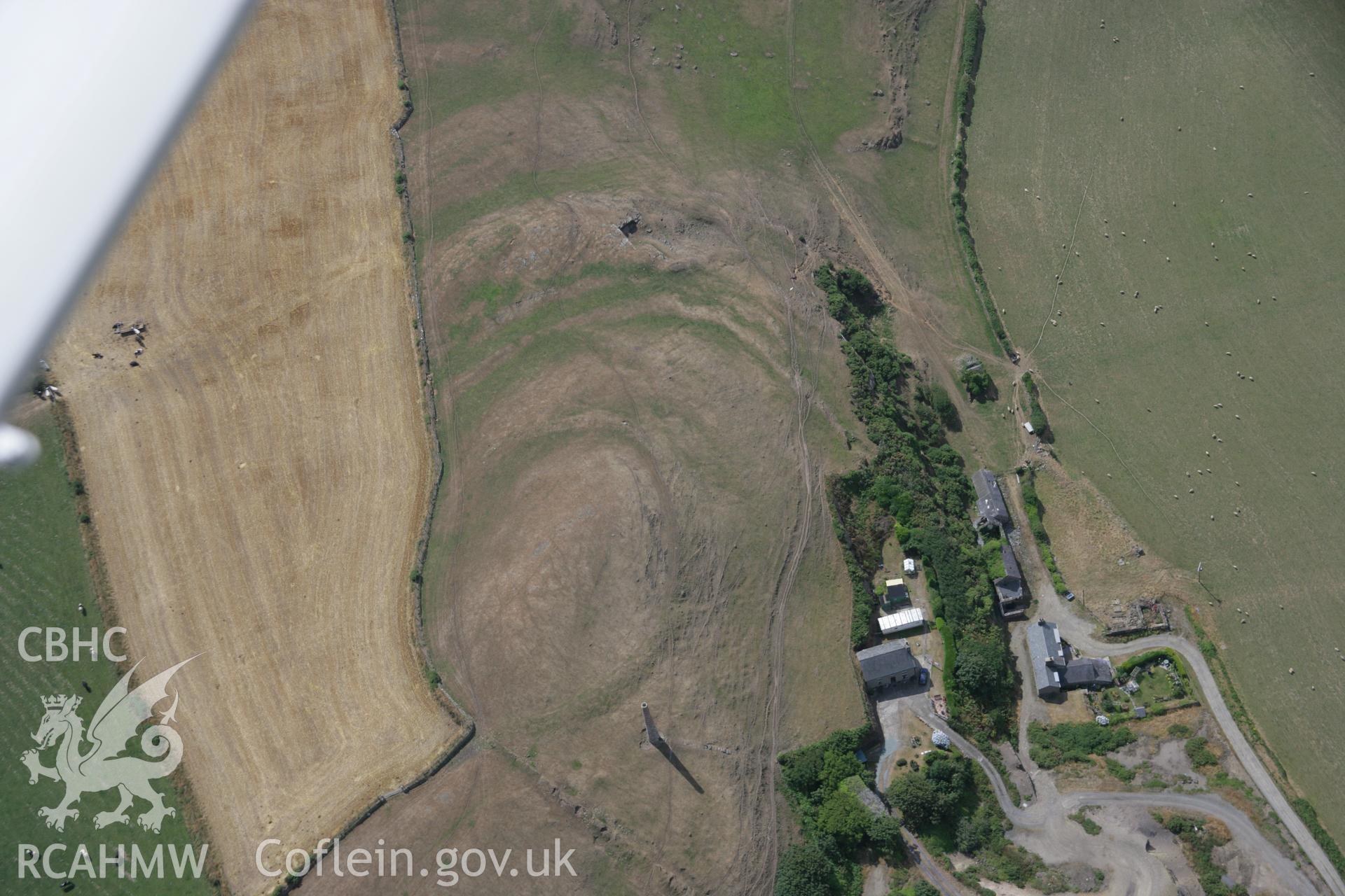 RCAHMW colour oblique aerial photograph of Castell Hillfort with parching revealing aditonal lines of defence. Taken on 03 August 2006 by Toby Driver.