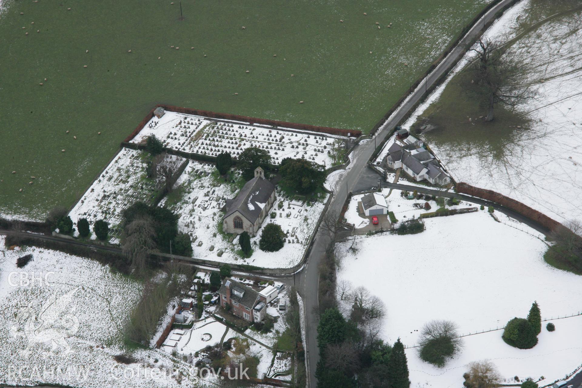 RCAHMW colour oblique aerial photograph of St Meugan's Church, Llanrhydd, from the east. Taken on 06 March 2006 by Toby Driver.