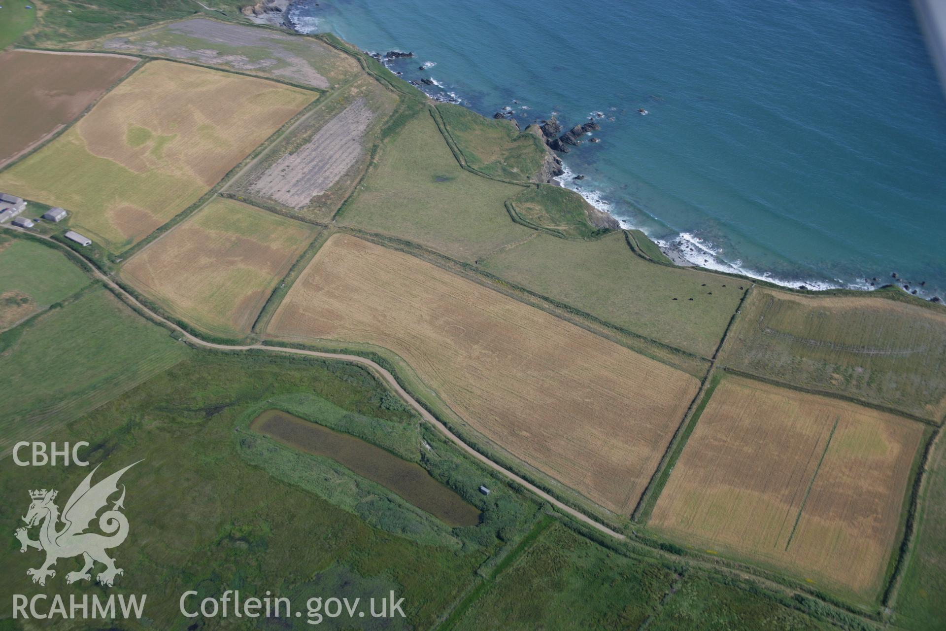 RCAHMW colour oblique aerial photograph of Runwayskiln Prehistoric Settlement Cropmarks. Taken on 24 July 2006 by Toby Driver.