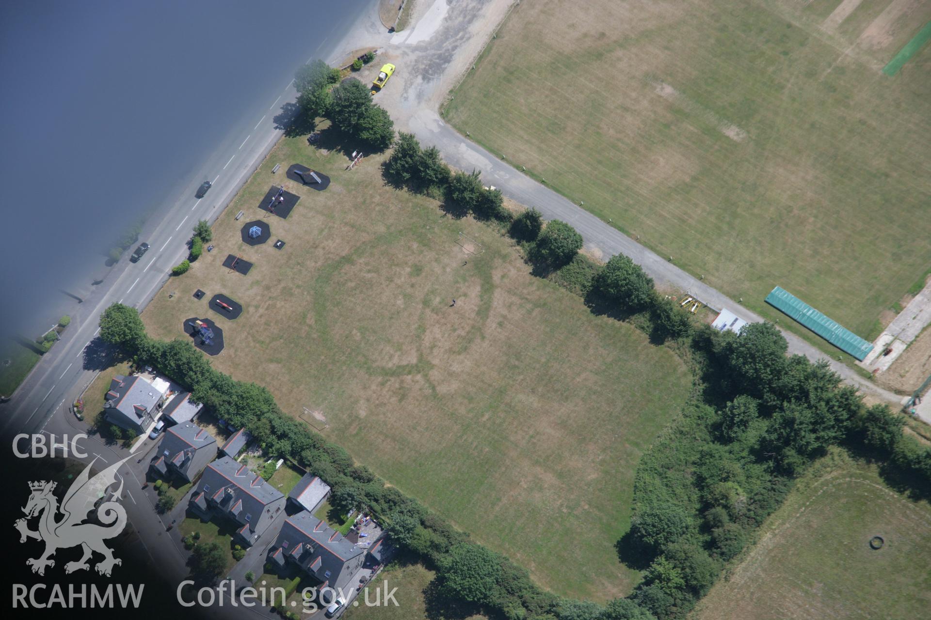 RCAHMW colour oblique aerial photograph showing cropmark of prehistoric defended enclosure known as King George's Field Enclosure, viewed from the north-west. Taken on 03 August 2006 by Toby Driver.