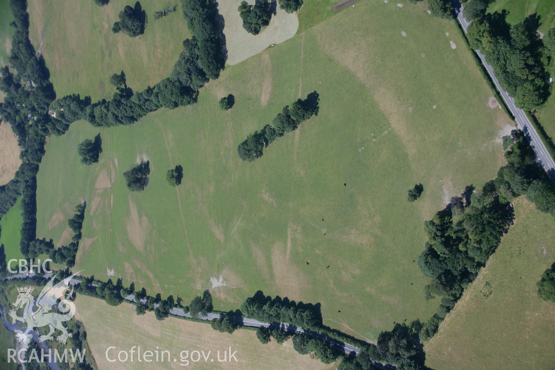 RCAHMW colour oblique aerial photograph showing parchmarks near Dolau Garden. Taken on 17 July 2006 by Toby Driver.