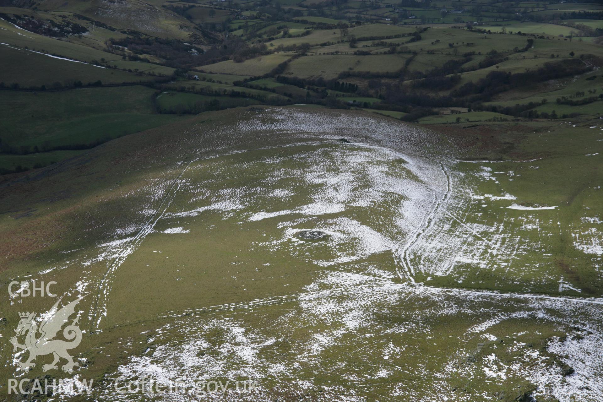 RCAHMW colour oblique aerial photograph of Corndon Hill Barrow V from the north-east. Taken on 06 March 2006 by Toby Driver.