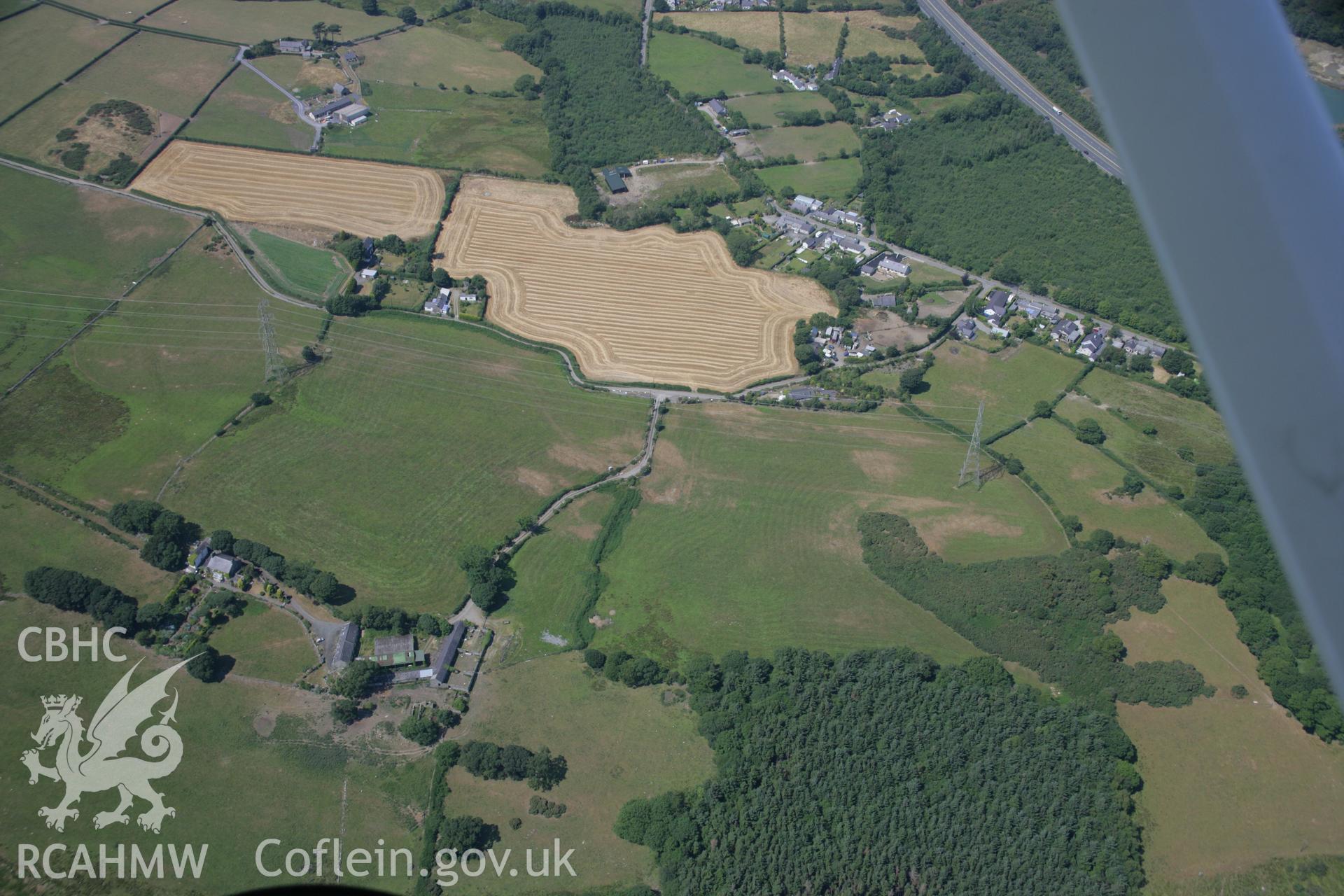 RCAHMW colour oblique aerial photograph of St George's Church and nearby parchmarks at Waen Wen. Taken on 18 July 2006 by Toby Driver