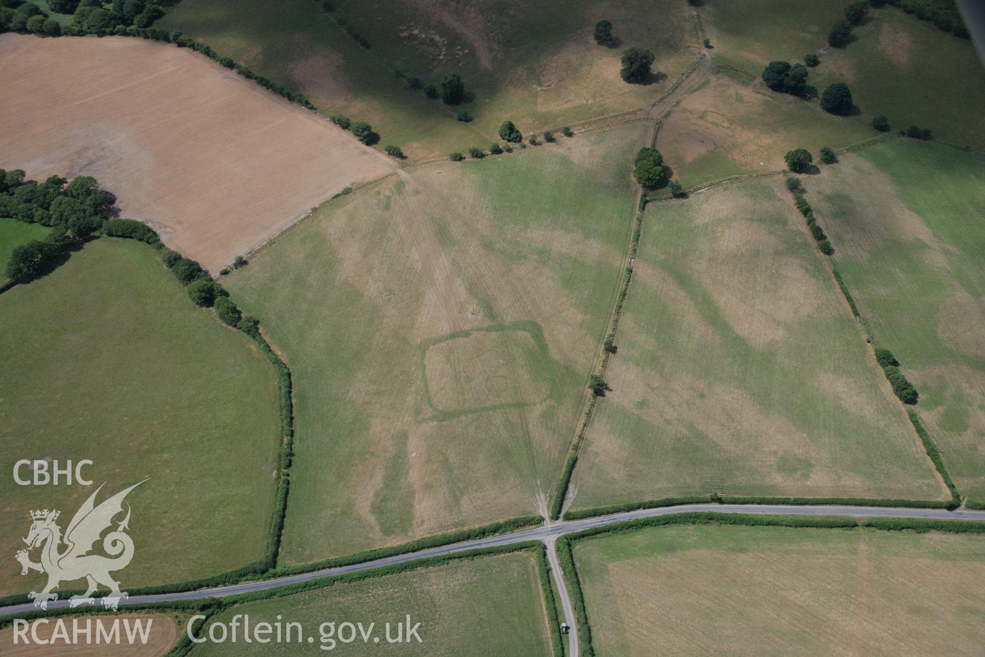 RCAHMW colour oblique aerial photograph of cropmark enclosures west of Caerau. Taken on 27 July 2006 by Toby Driver.