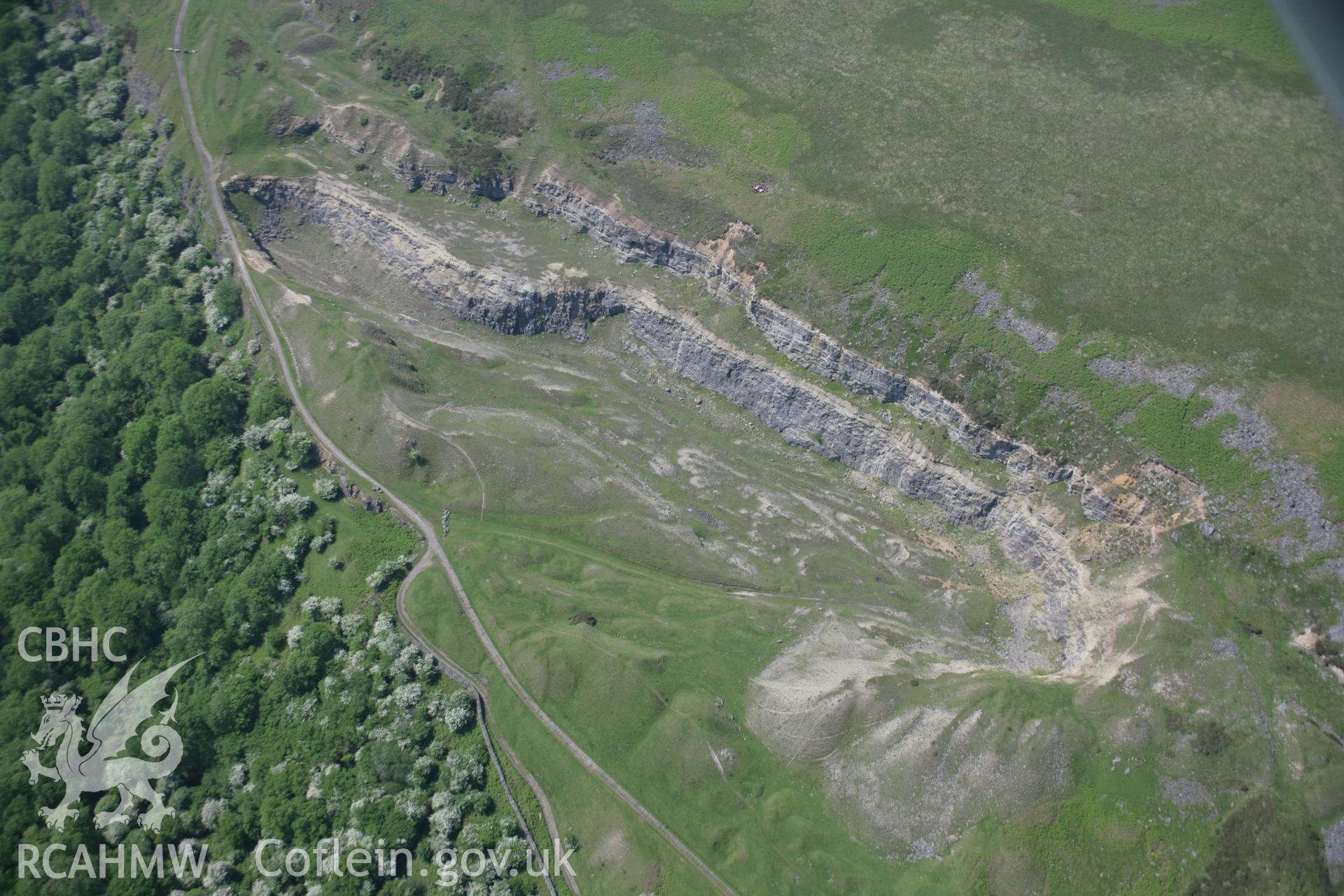 RCAHMW colour oblique aerial photograph of Tyla West Quarry, Gilwern Hill, Clydach, from the north-east. Taken on 09 June 2006 by Toby Driver.