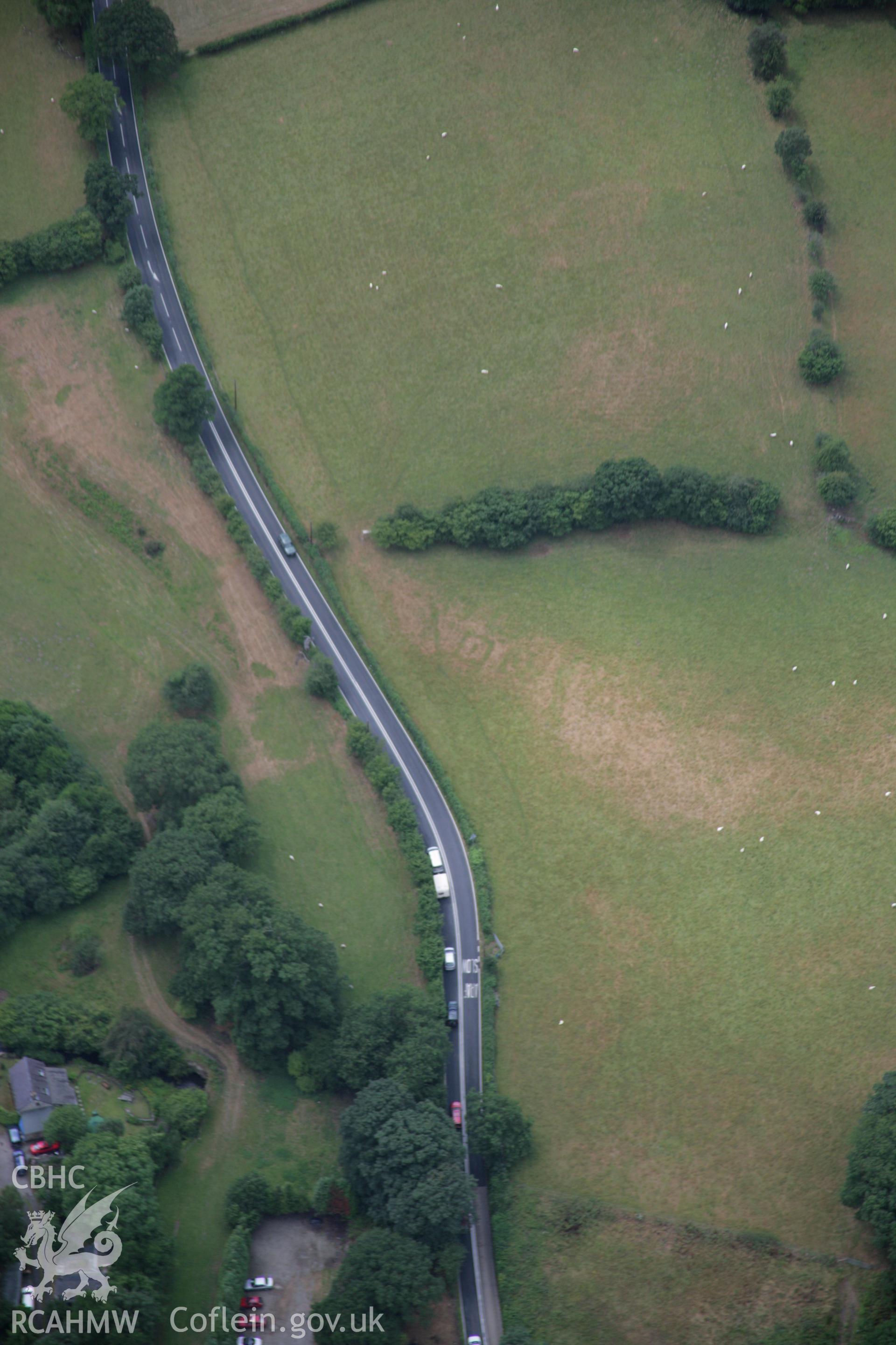 RCAHMW colour oblique aerial photograph of Druid Square Barrows and the Roman road. Taken on 31 July 2006 by Toby Driver.