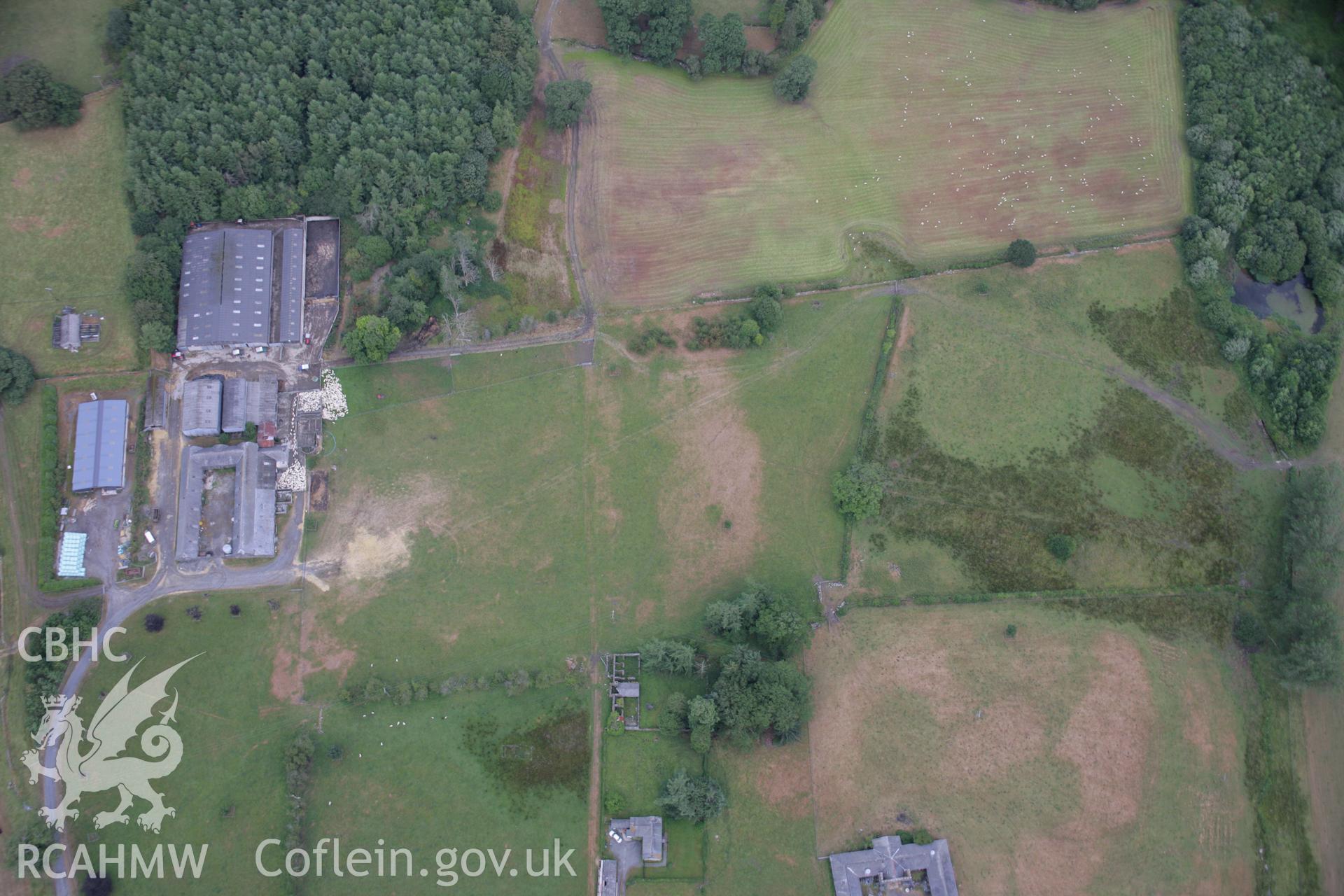 RCAHMW colour oblique aerial photograph of Rhiwlas Garden, Bala, fromm the south-west showing farm buildings, parchmarks of a silage bale stack and other marks. Taken on 31 July 2006 by Toby Driver.