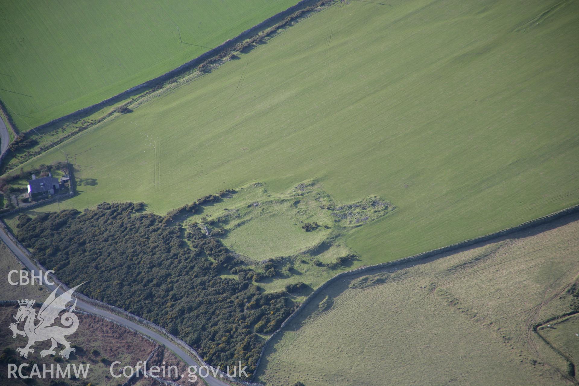 RCAHMW colour oblique aerial photograph of Rhiw Defended Enclosure. A landscape view from the east. Taken on 09 February 2006 by Toby Driver.