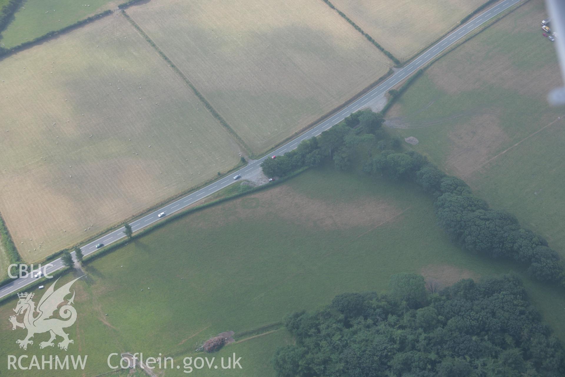 RCAHMW colour oblique aerial photograph of cropmark features north of Croes Faen possibly representing early Medieval Barrows. Taken on 21 July 2006 by Toby Driver.