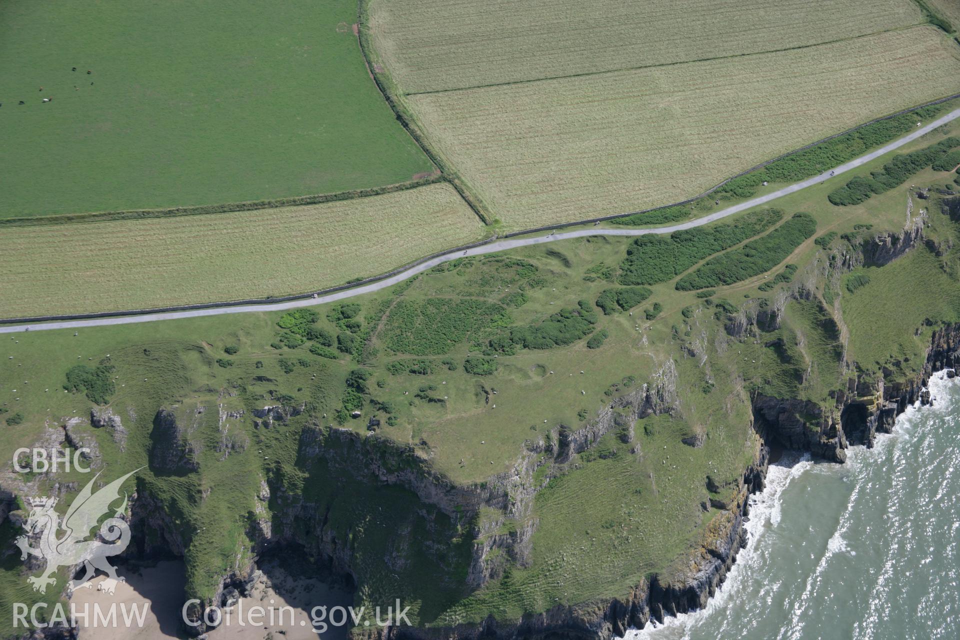 RCAHMW colour oblique aerial photograph of Old Castle Promontory Fort, Rhossili. Taken on 11 July 2006 by Toby Driver.