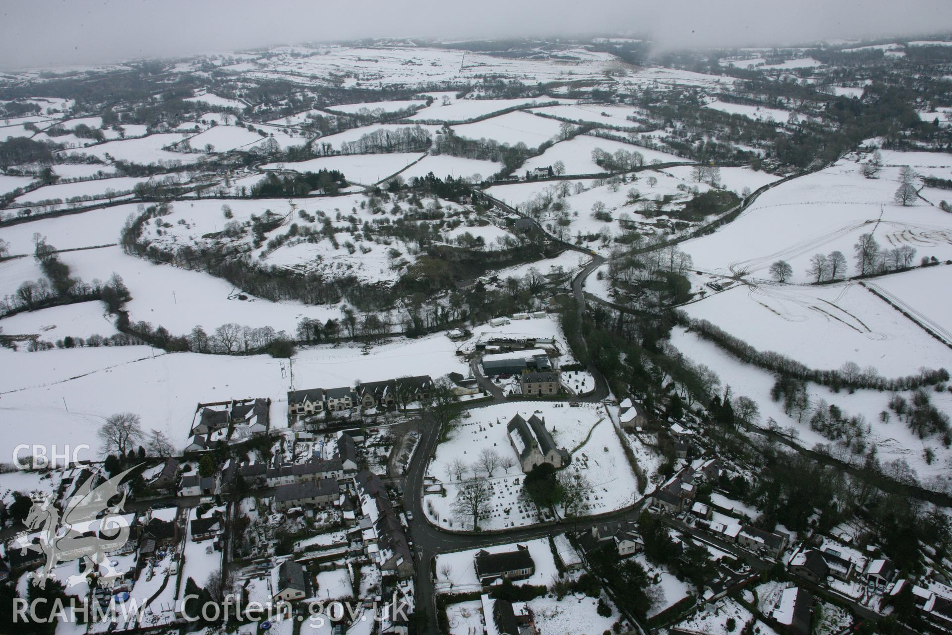 RCAHMW colour oblique aerial photograph of St Garmon's Church, Llanarmon Yn Ial, from the west. Taken on 06 March 2006 by Toby Driver.