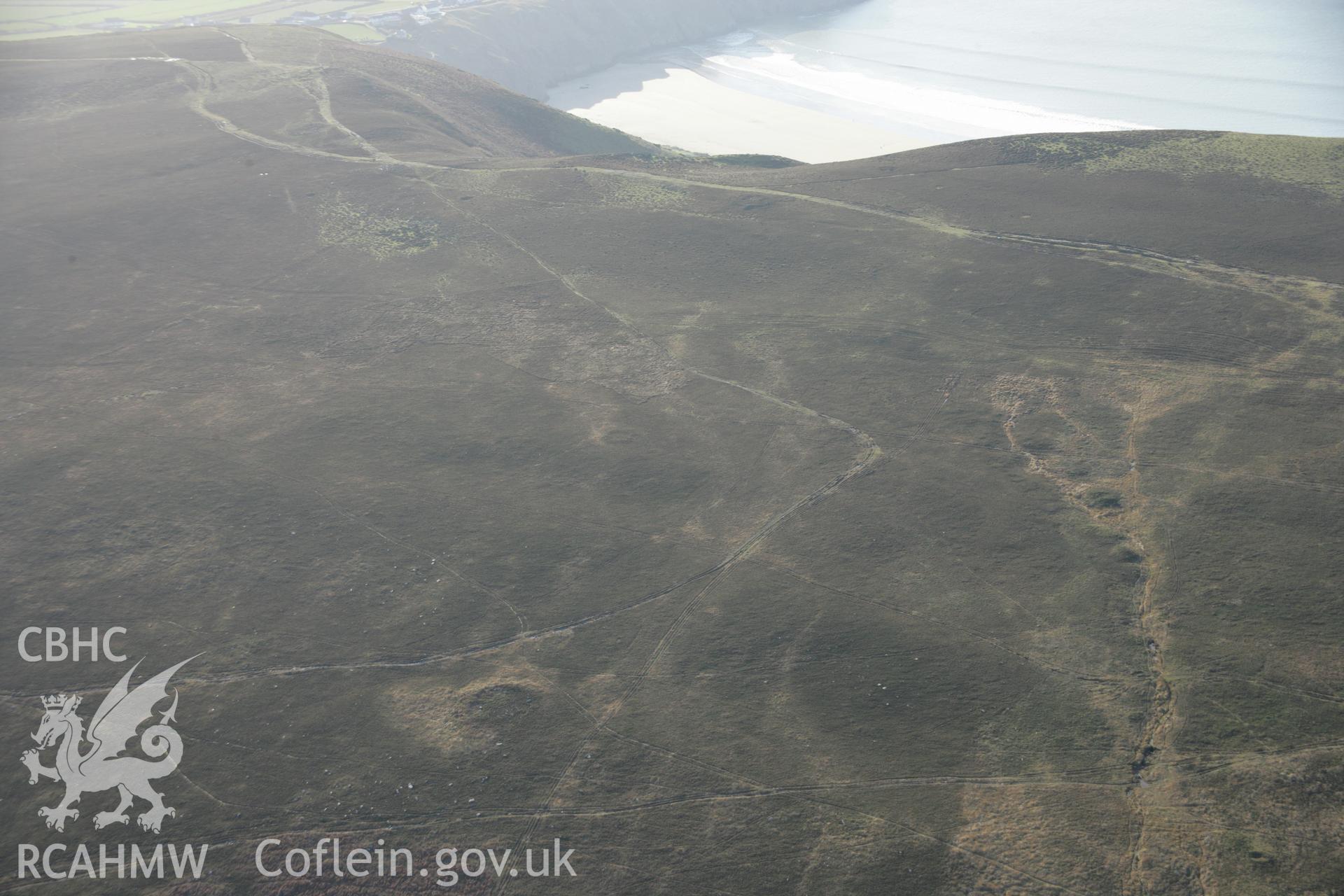 RCAHMW colour oblique aerial photograph of Rhossili Down pre-historic field boundary and cairns on Rhossili Down, viewed from the north-east. Taken on 26 January 2006 by Toby Driver