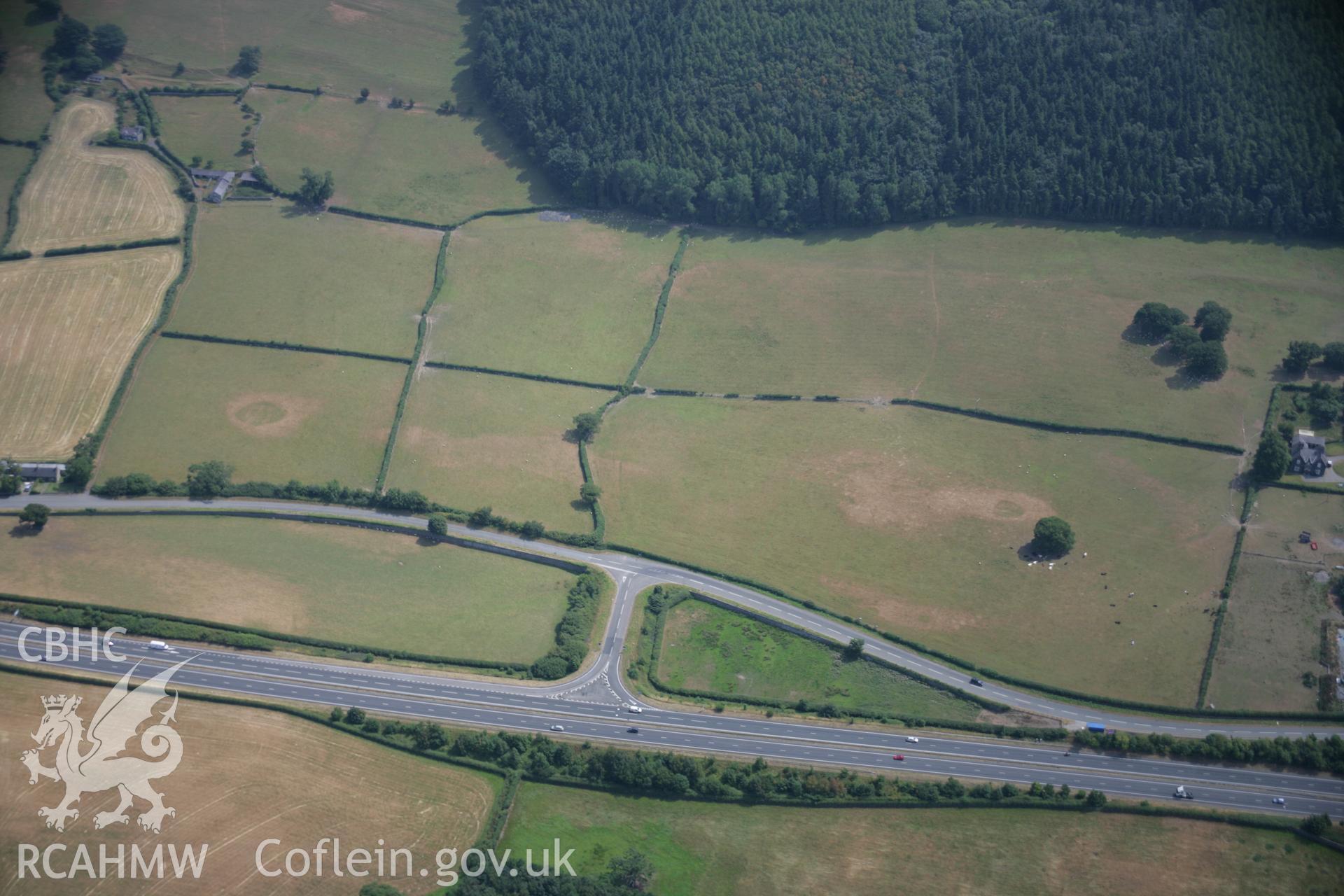 RCAHMW colour oblique aerial photograph of sections of the Roman Road at Tai'r-Meibion showing as a parchmark. Taken on 25 July 2006 by Toby Driver.