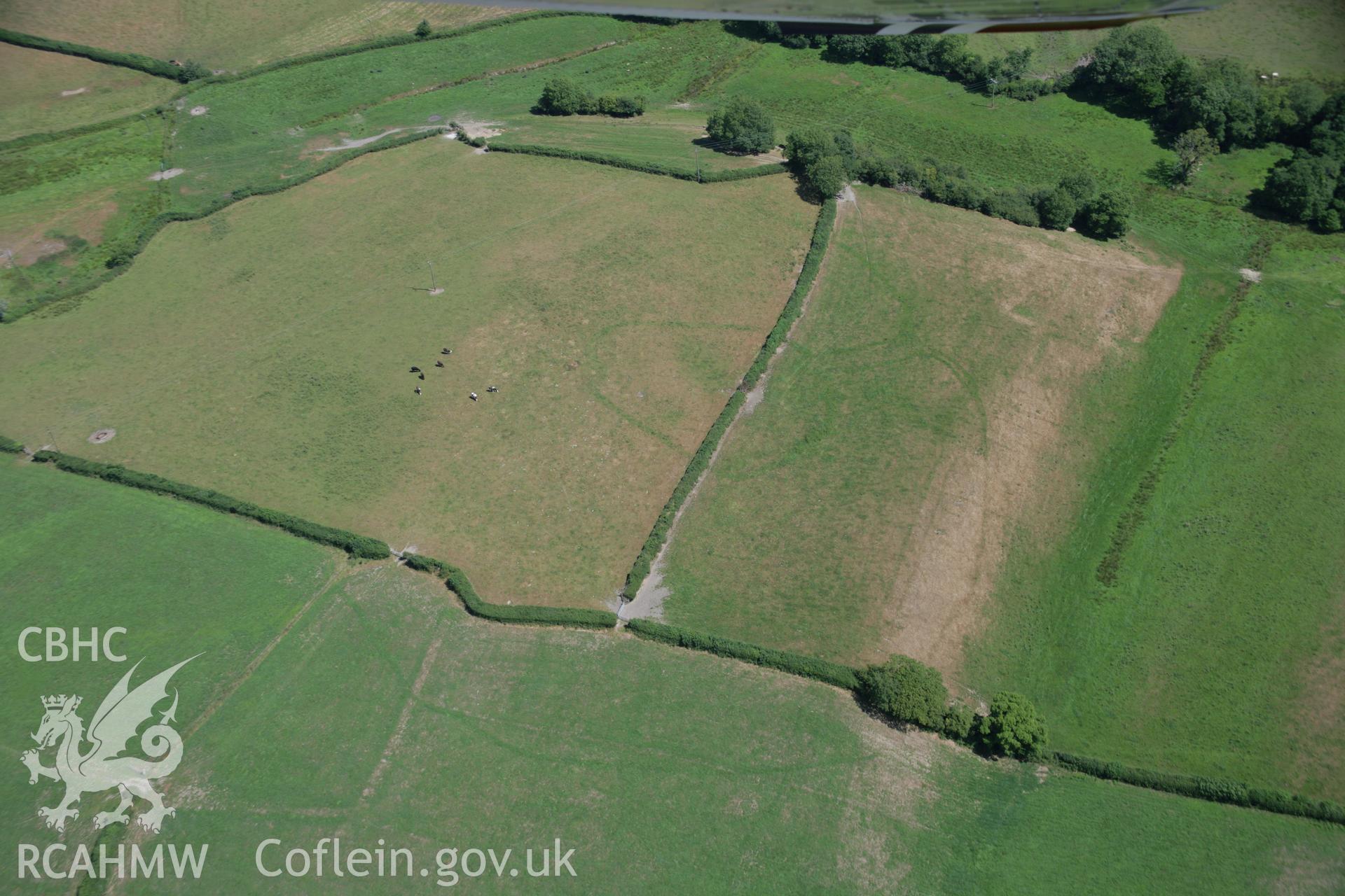 RCAHMW colour oblique aerial photograph of a cropmark enclosure south of Blaen-Lliwe. Taken on 24 July 2006 by Toby Driver.