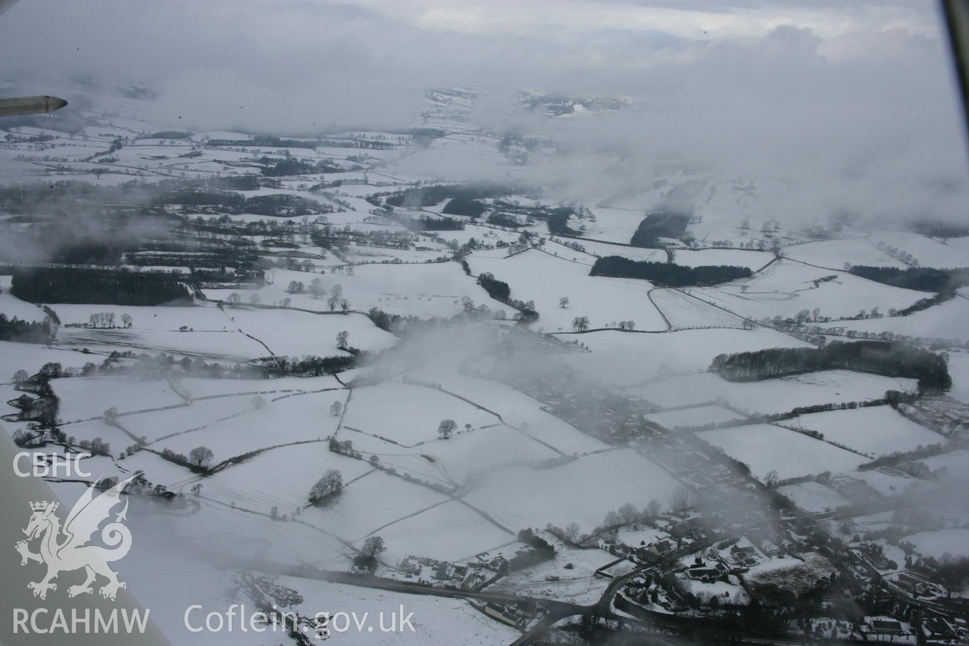 RCAHMW colour oblique aerial photograph of St Tecla's Church, Llandegla, from the south under snow. Taken on 06 March 2006 by Toby Driver.