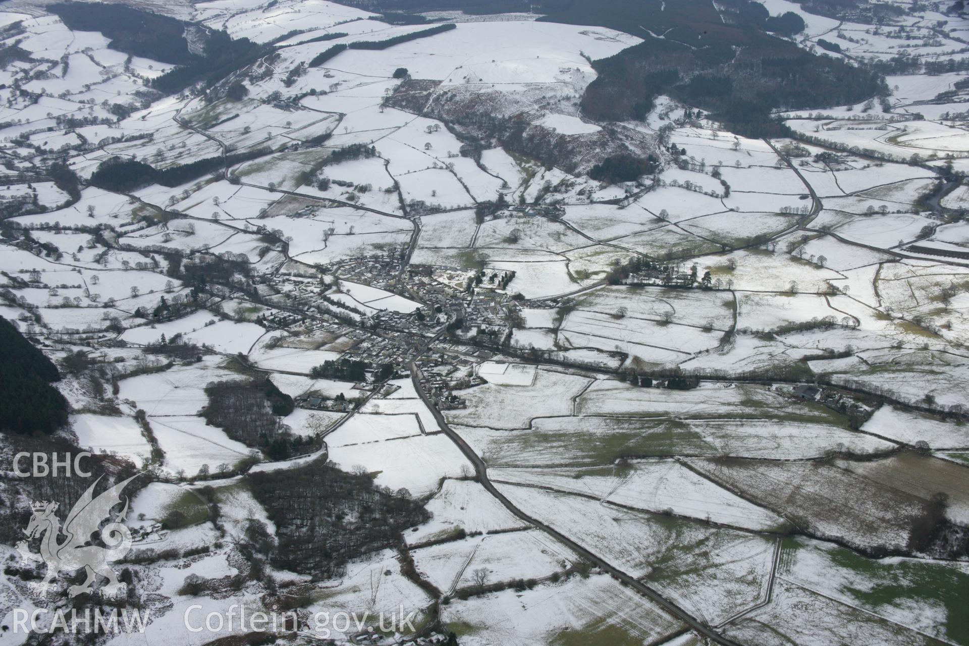 RCAHMW colour oblique aerial photograph of Llandrillo village in snow viewed from the north-east. Taken on 06 March 2006 by Toby Driver.