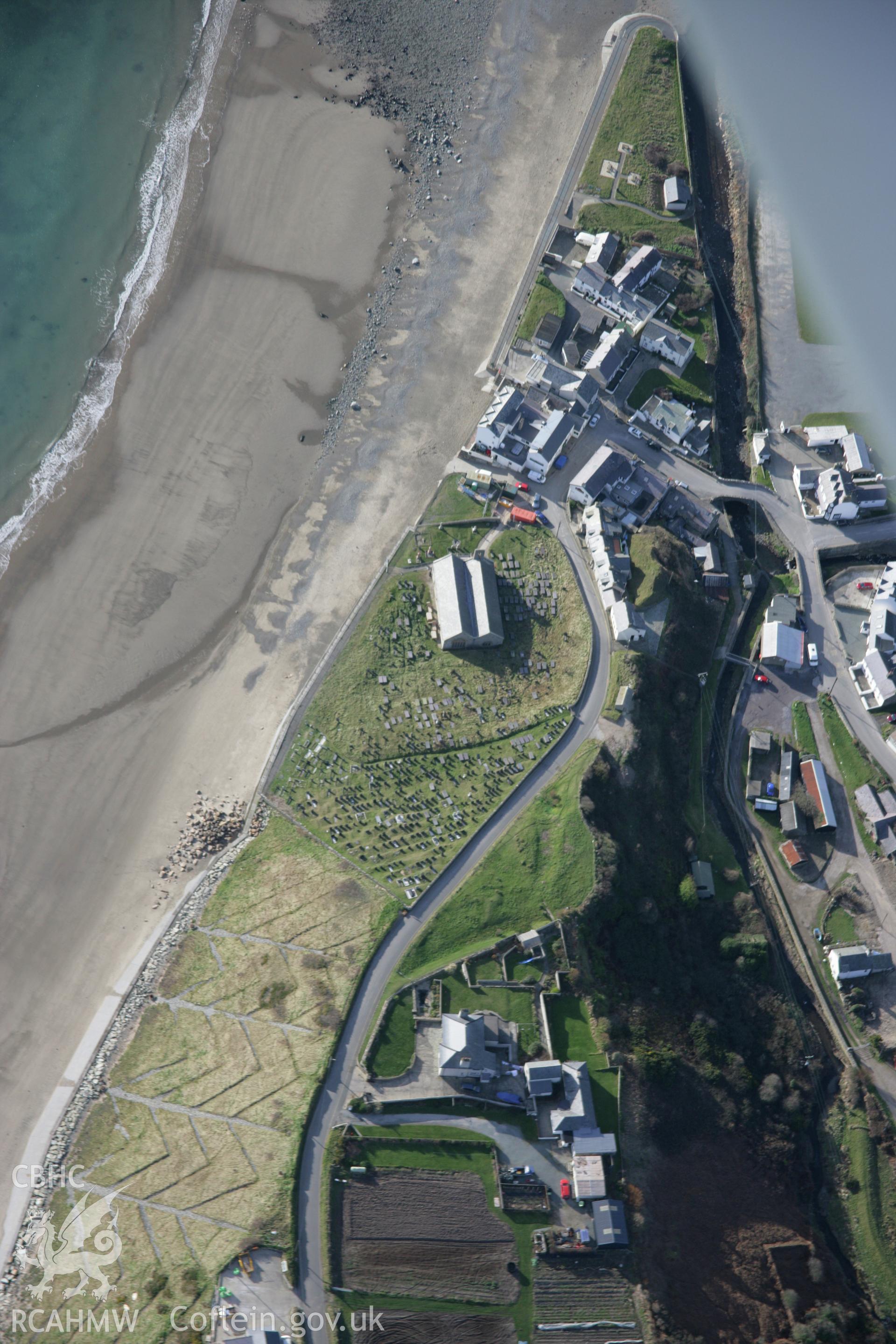 RCAHMW colour oblique aerial photograph of St Hywyns Church, Aberdaron, from the east. Taken on 09 February 2006 by Toby Driver.