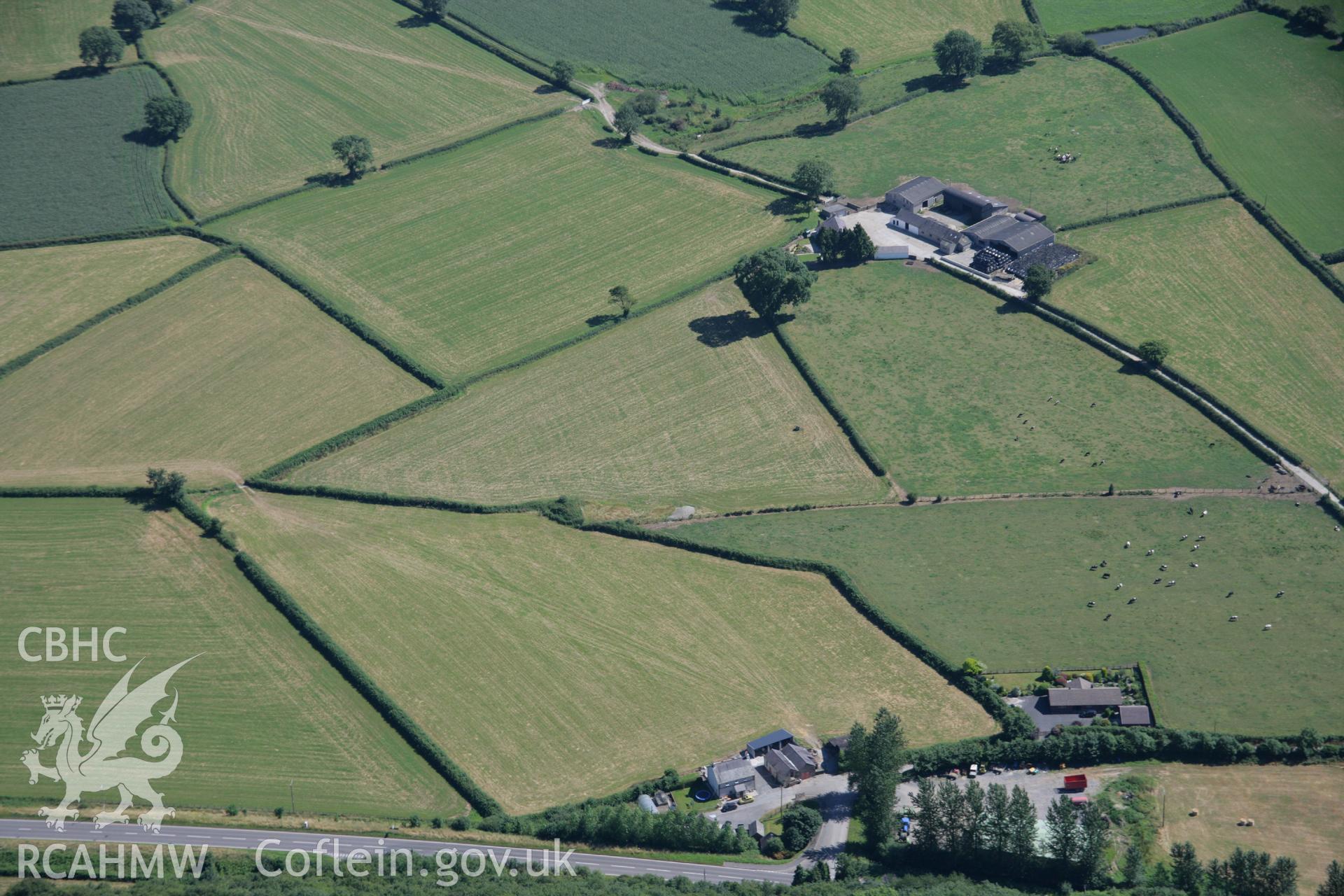 RCAHMW colour oblique aerial photograph of a round barrow 200m south southwest of Felin-Wen-Isaf. Taken on 24 July 2006 by Toby Driver.