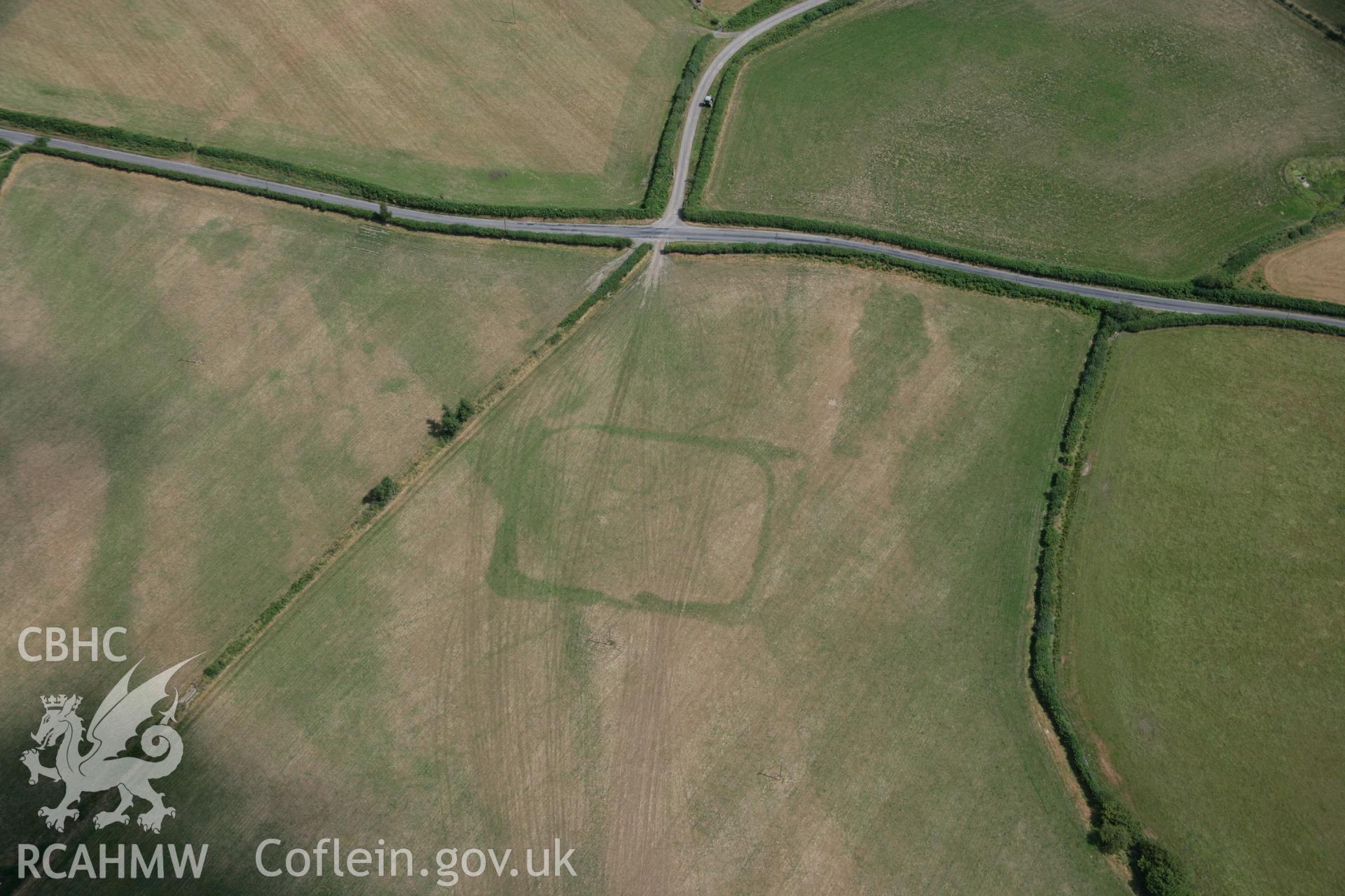 RCAHMW colour oblique aerial photograph of cropmark enclosures west of Caerau. Taken on 27 July 2006 by Toby Driver.