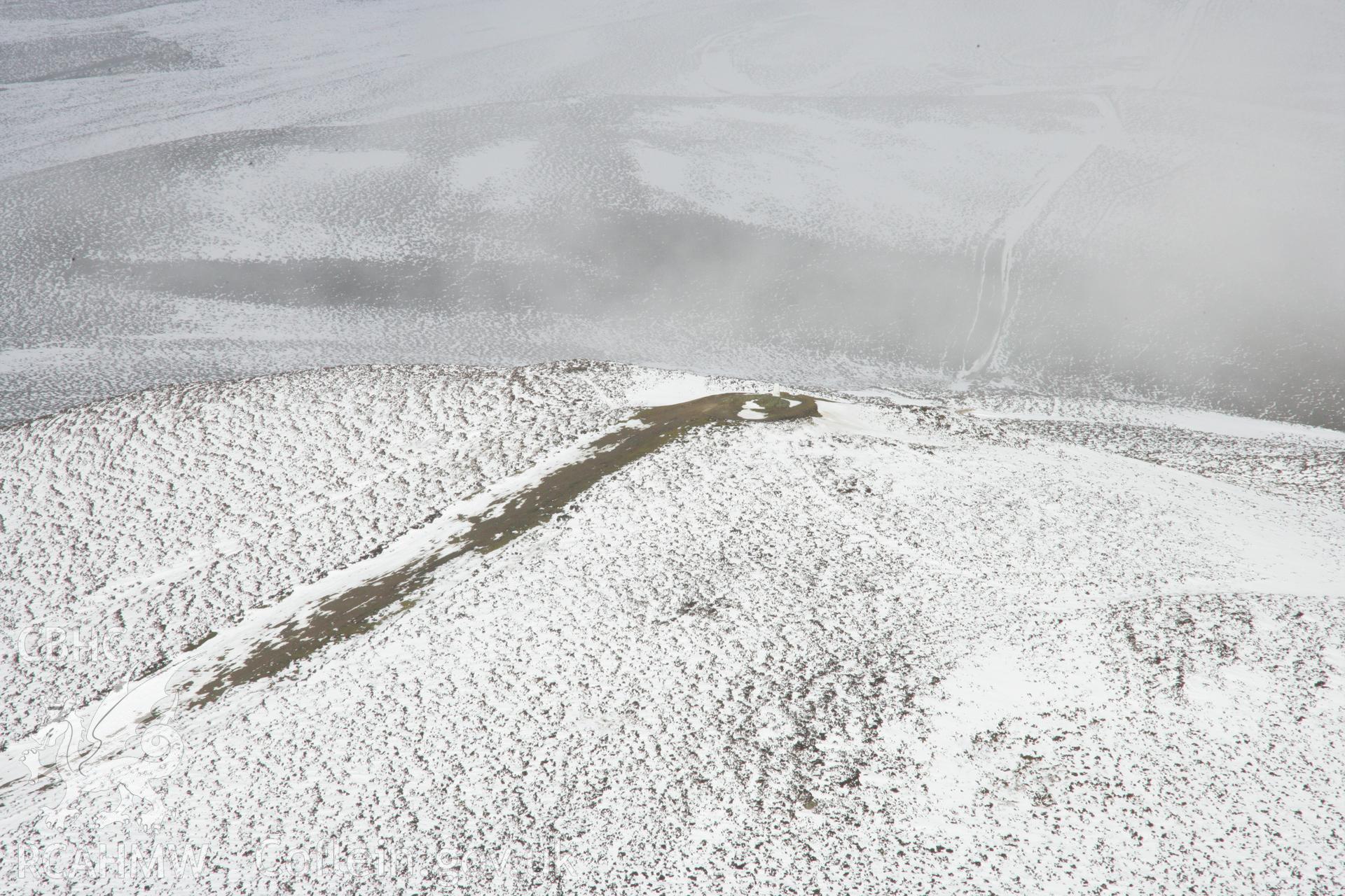 RCAHMW colour oblique aerial photograph of Moel Morfydd hilltop near Moel-y-Gaer Hillfort, Llantysilio viewed from the south. Taken on 06 March 2006 by Toby Driver.