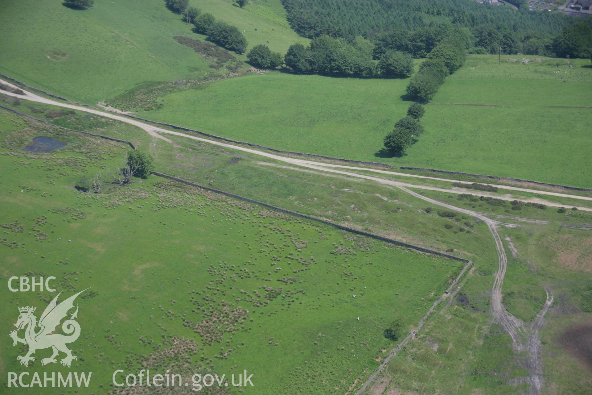 RCAHMW colour oblique aerial photograph of Pont Bren Gwyn Ring Cairn from the south-west. Taken on 09 June 2006 by Toby Driver.