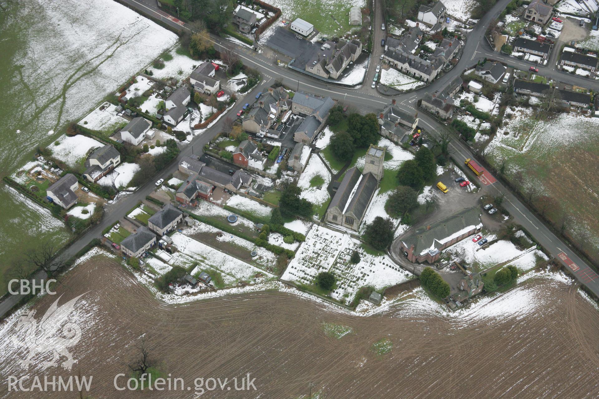 RCAHMW colour oblique aerial photograph of St Cynfarch and St Mary's Church, Llanfair Dyffryn Clwyd, under snow from the north-east. Taken on 06 March 2006 by Toby Driver.