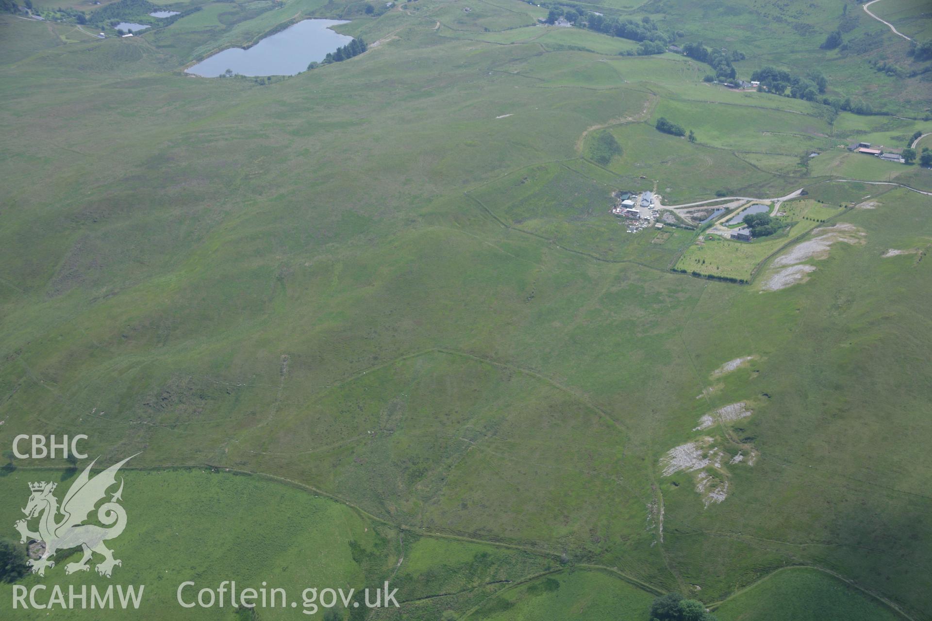 RCAHMW colour oblique aerial photograph of Bryn Rhosau Cairns I and II. Taken on 04 July 2006 by Toby Driver