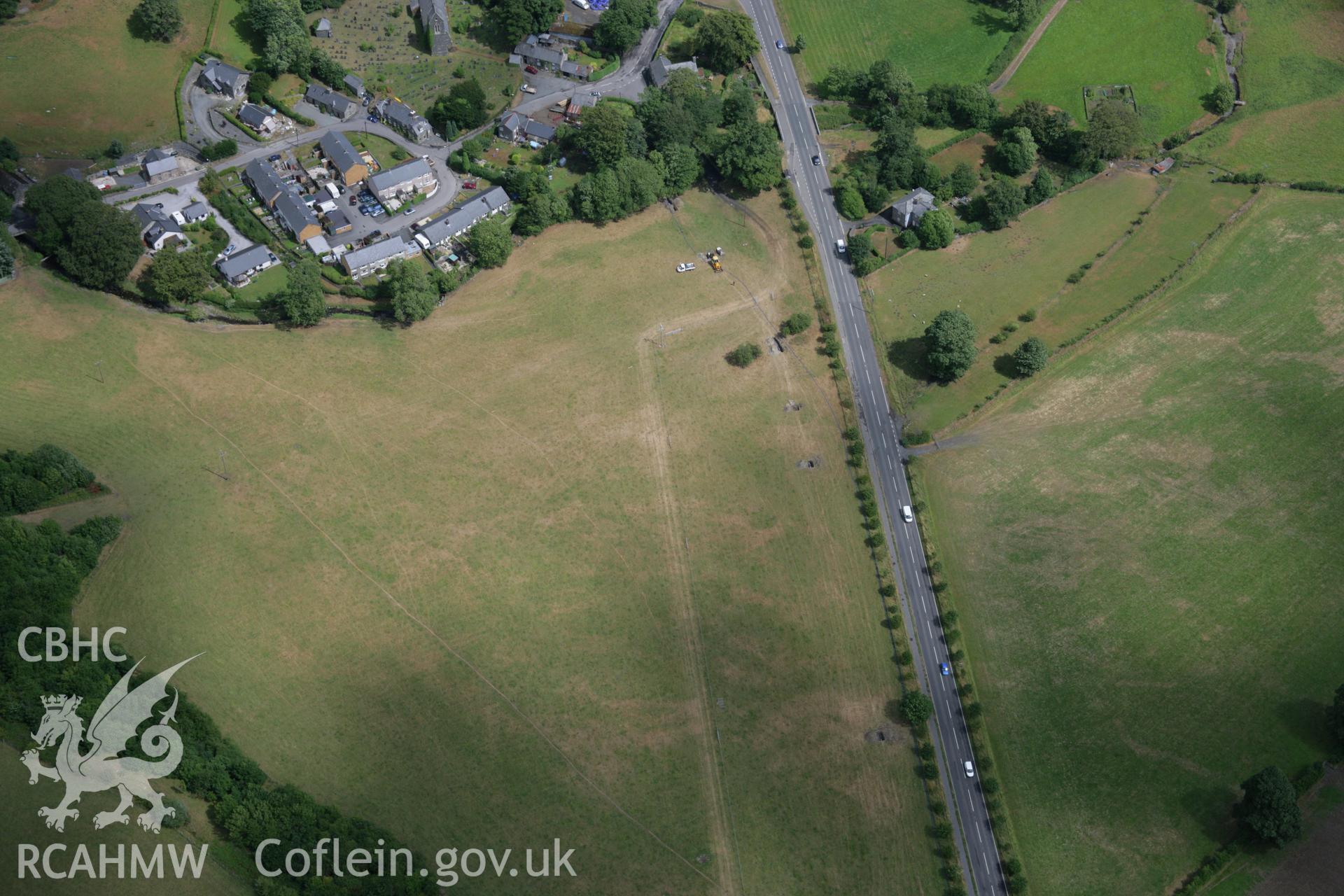 RCAHMW colour oblique aerial photograph of Llanfor Roman Temporary Camp II, visible in cropmarks, viewed from the west. Taken on 31 July 2006 by Toby Driver.