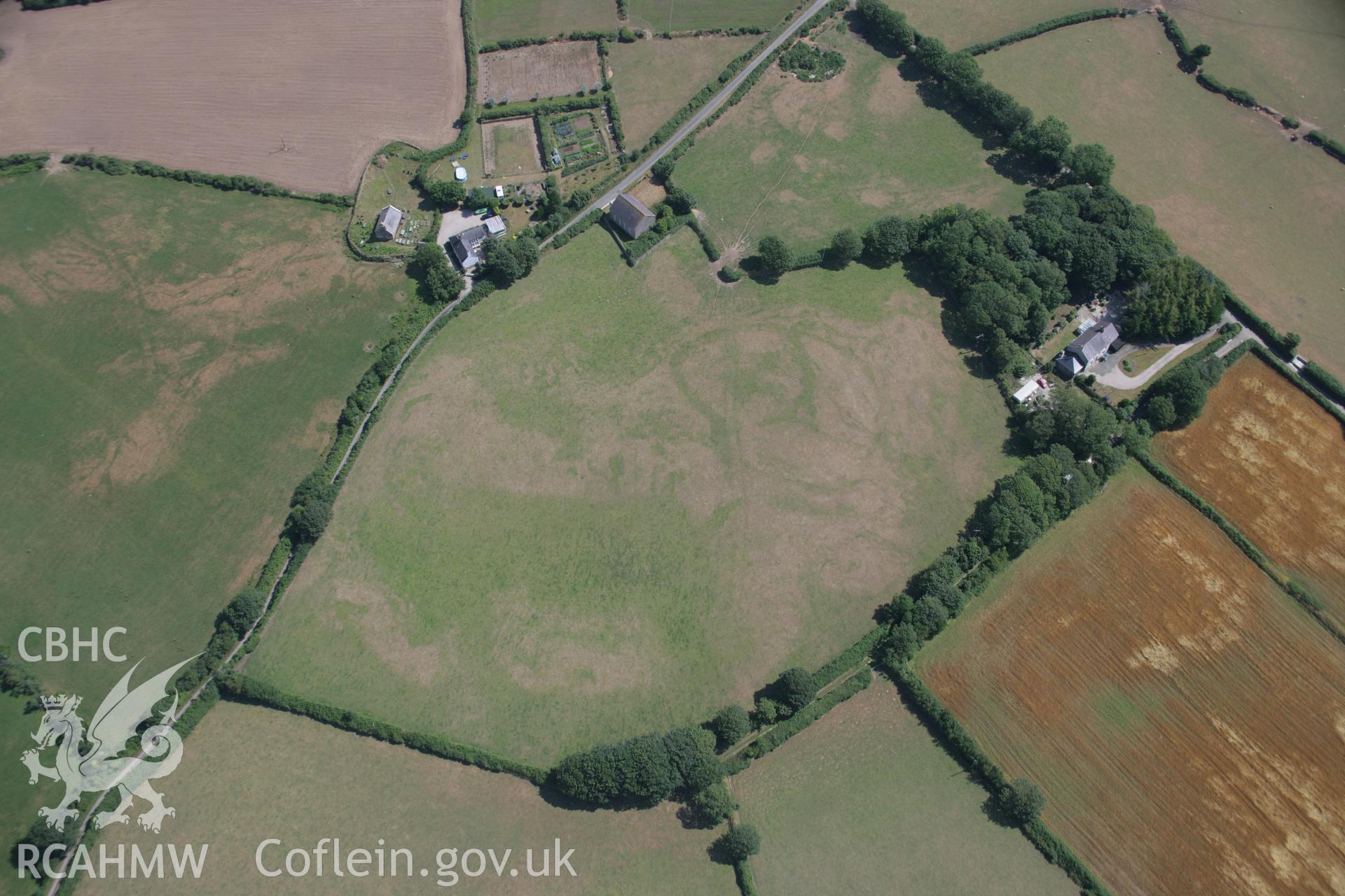 RCAHMW colour oblique aerial photograph of Capel Peniel, showing cropmark of defended enclosure and early church, viewed from the west. Taken on 03 August 2006 by Toby Driver