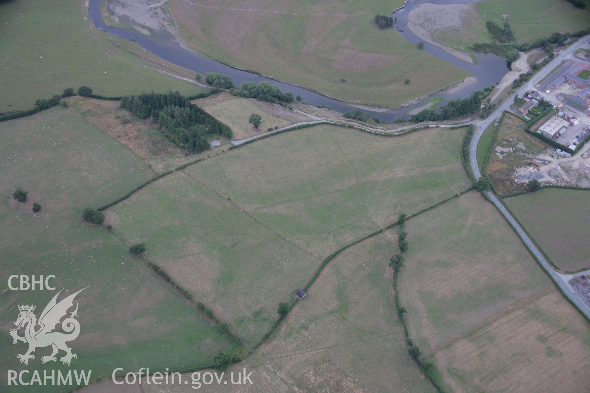 RCAHMW colour oblique aerial photograph showing parchmarks in grass at Llwyn-y-Brain Roman Fort. Taken on 14 August 2006 by Toby Driver.