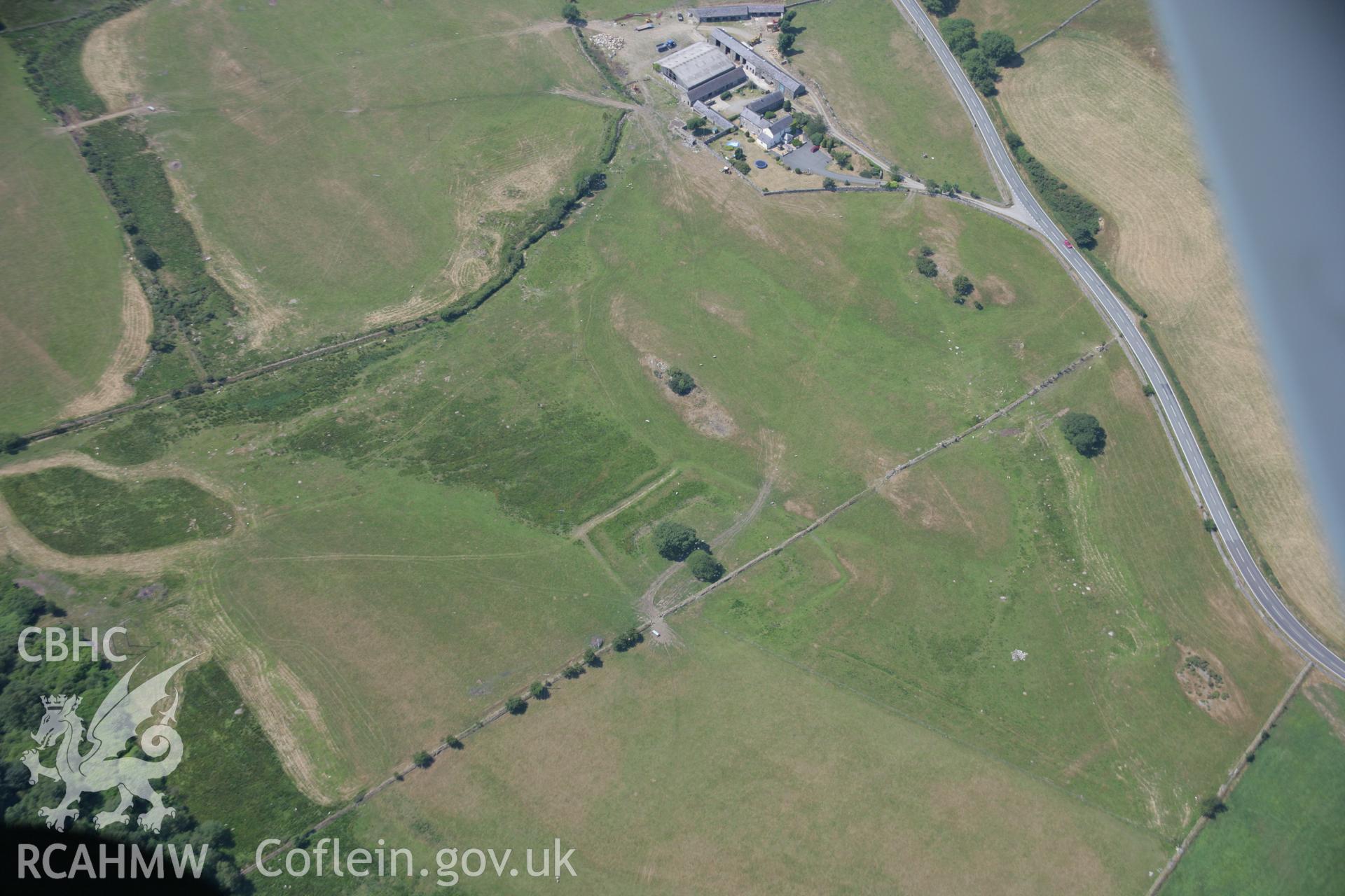 RCAHMW colour oblique aerial photograph of a rectangular earthwork 110m northwest of Coed Ty Mawr. Taken on 18 July 2006 by Toby Driver.